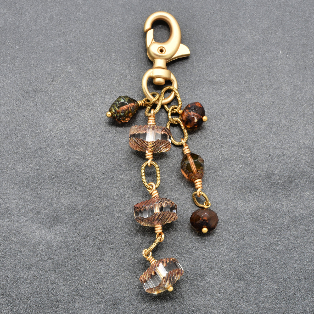 Smoky Reverie Handbag Charm featuring wire-wrapped etched Czech glass rondelles in smoky topaz with gold lobster claw, handmade by Ruby Acorn