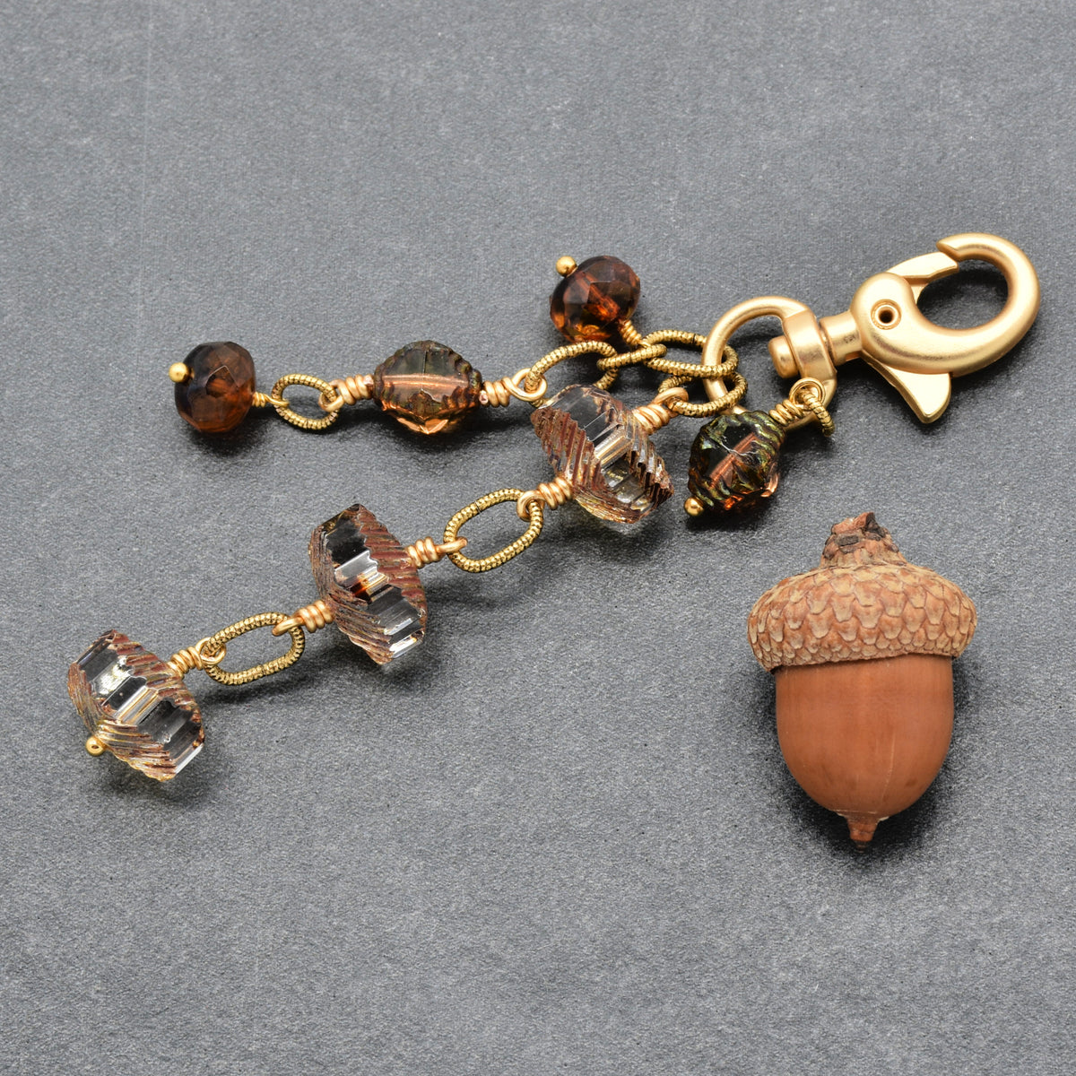 Smoky Reverie Handbag Charm featuring wire-wrapped etched Czech glass rondelles in smoky topaz with gold lobster claw, handmade by Ruby Acorn