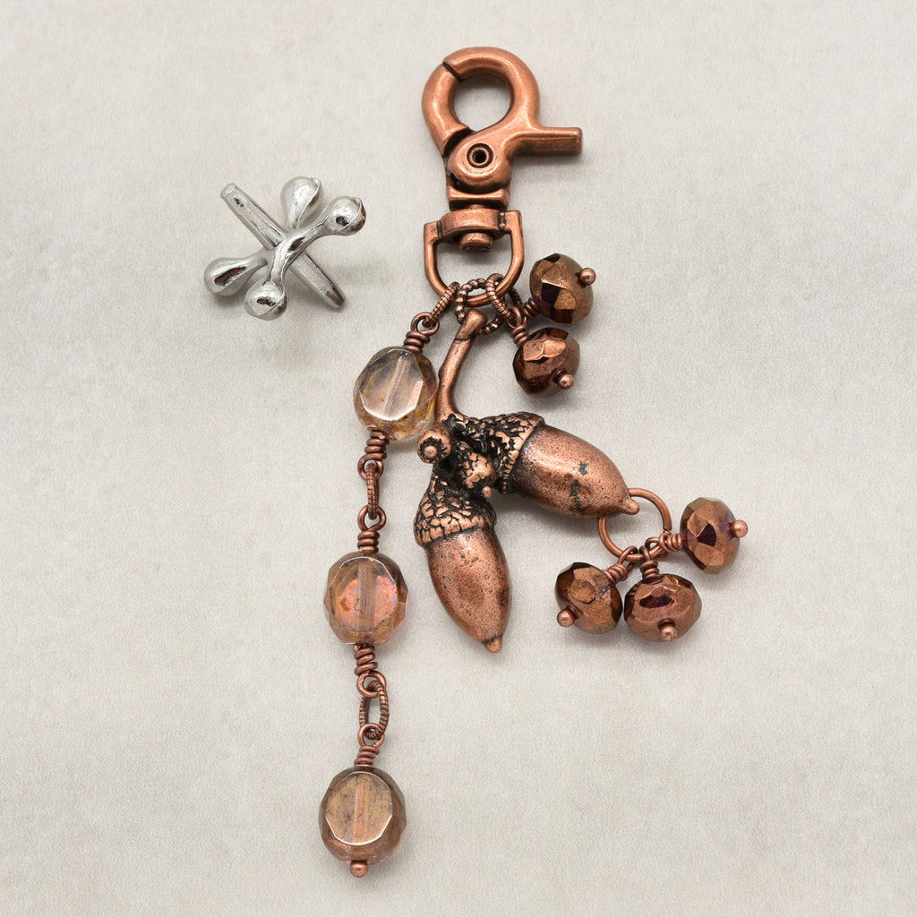 The Acorn Keeper Handbag Charm featuring a rare antique copper acorn focal with light topaz Czech glass charms, handmade by Ruby Acorn