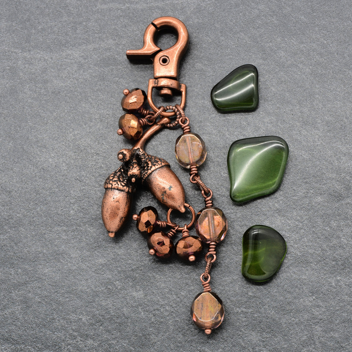 The Acorn Keeper Handbag Charm featuring a rare antique copper acorn focal with light topaz Czech glass charms, handmade by Ruby Acorn