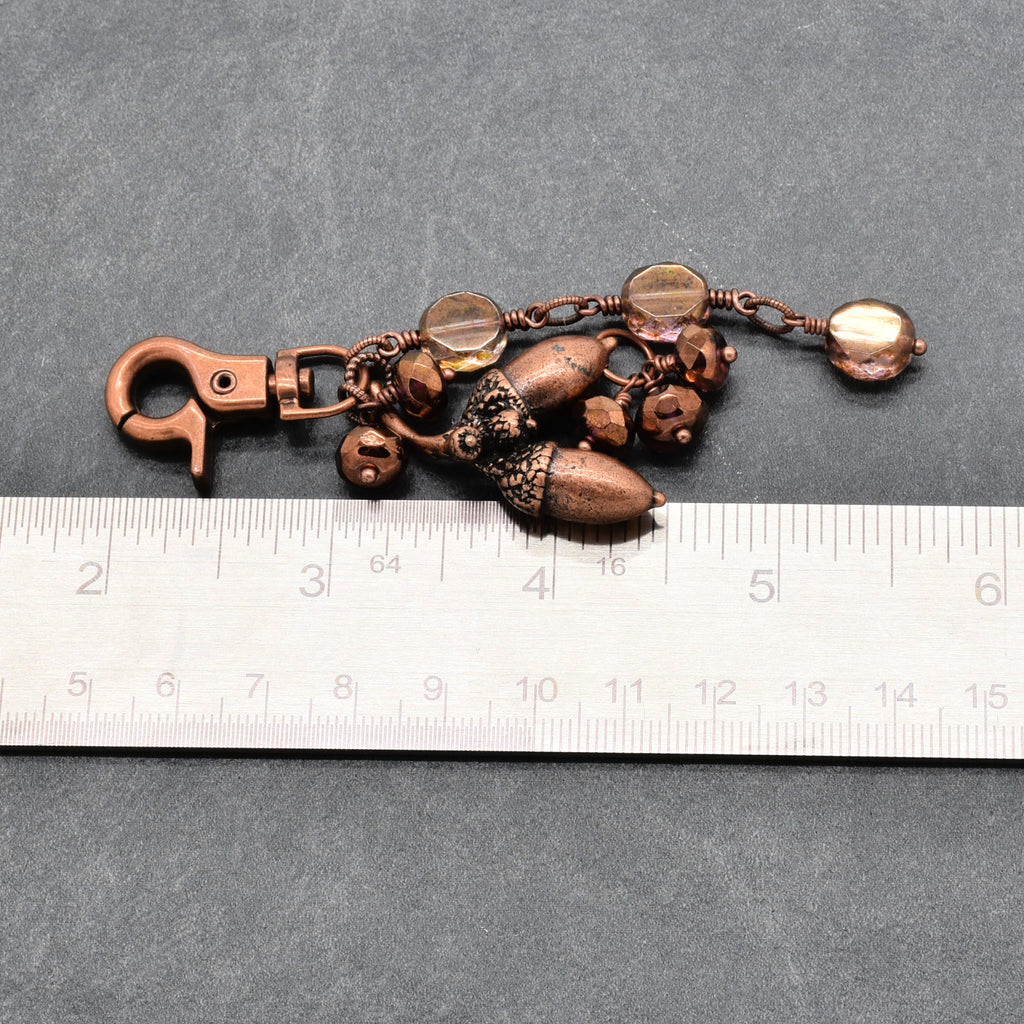 The Acorn Keeper Handbag Charm featuring a rare antique copper acorn focal with light topaz Czech glass charms, handmade by Ruby Acorn