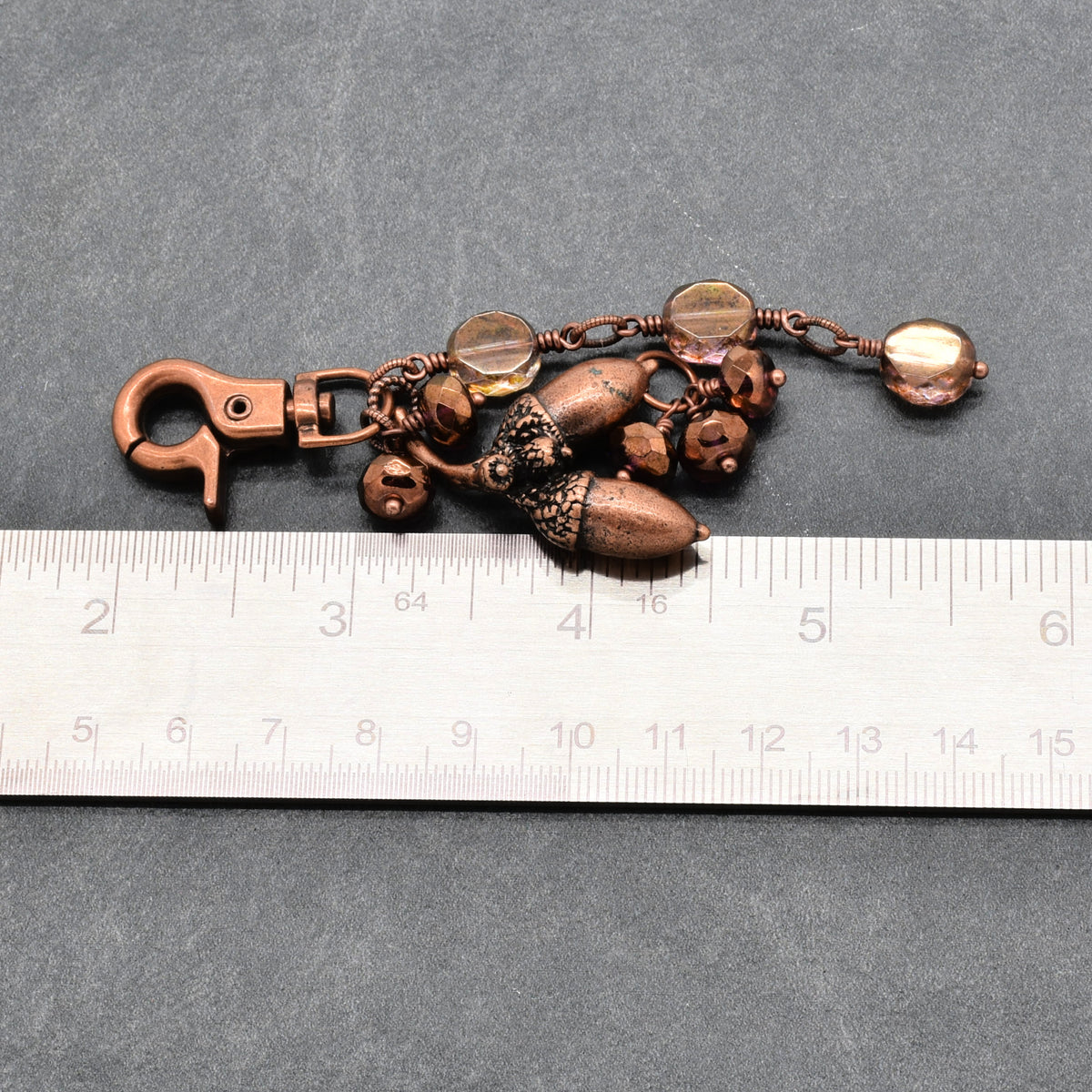 The Acorn Keeper Handbag Charm featuring a rare antique copper acorn focal with light topaz Czech glass charms, handmade by Ruby Acorn