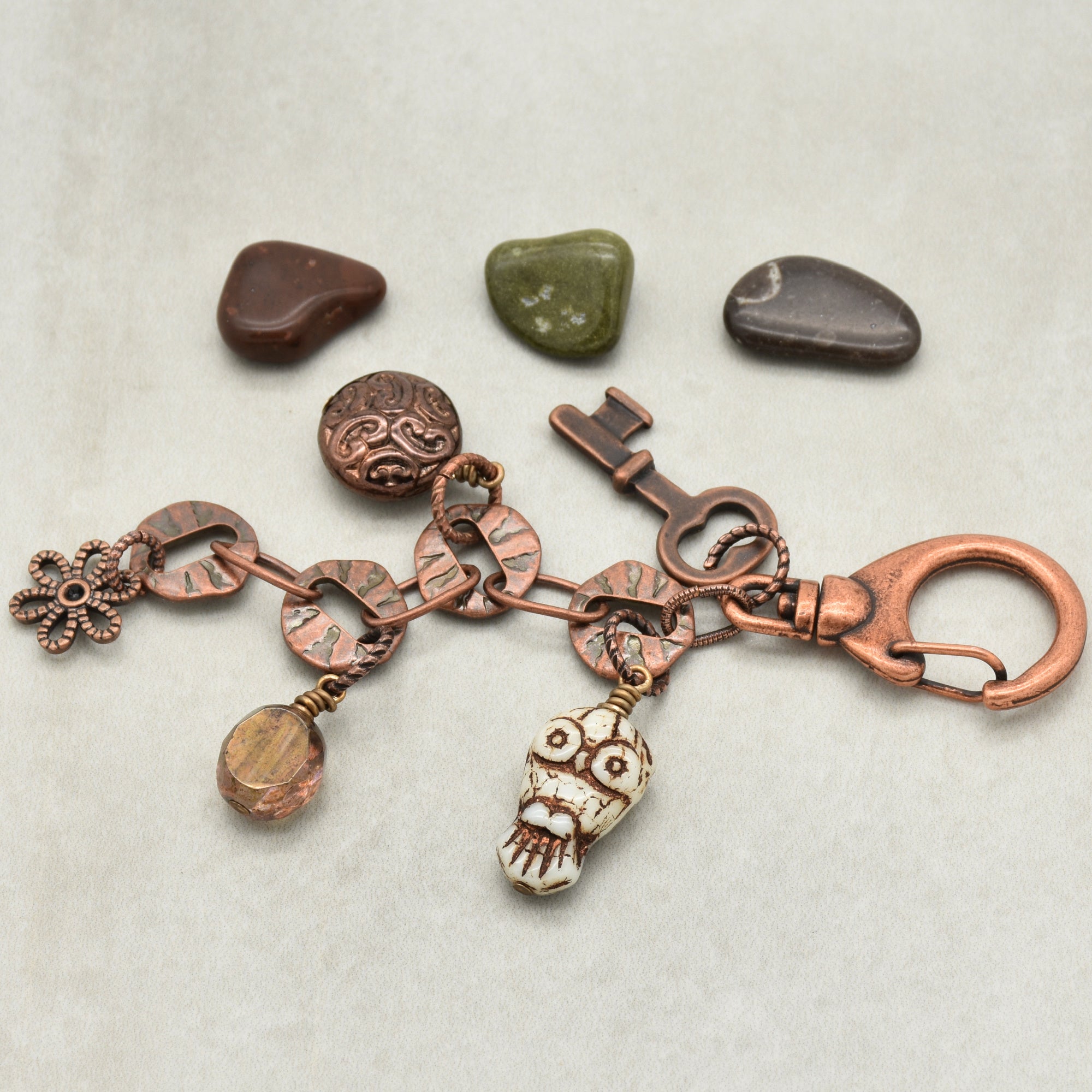 Copper keychain with various charms on a light background