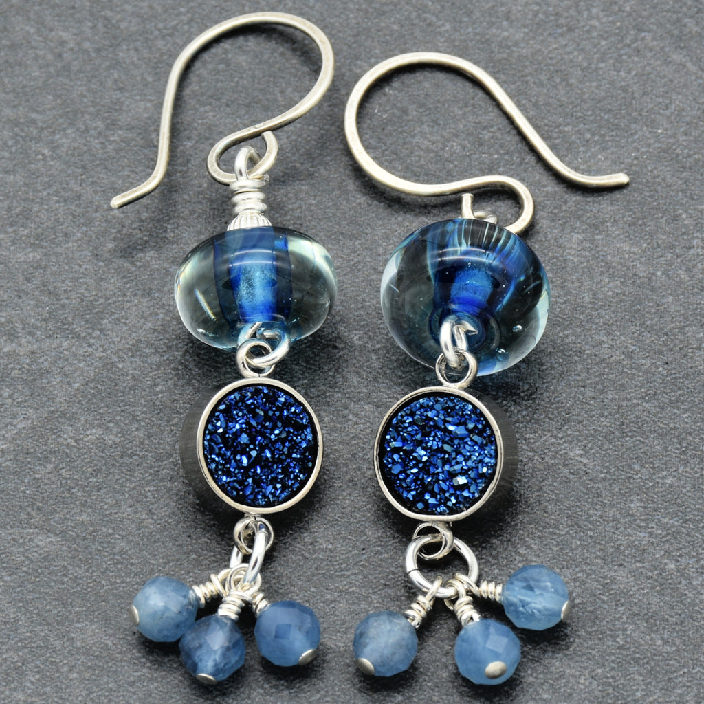 Blue glass and druzy earrings on a gray background