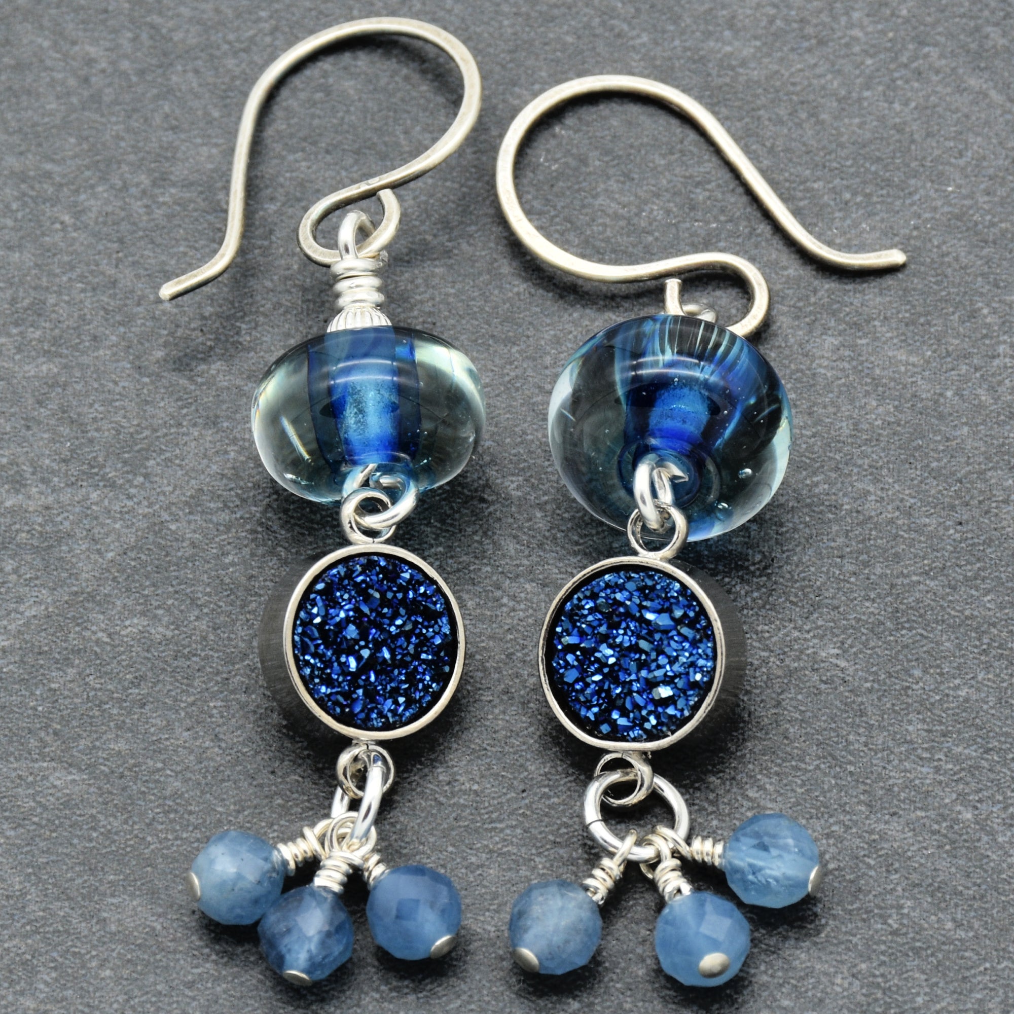 Blue glass and druzy earrings on a gray background