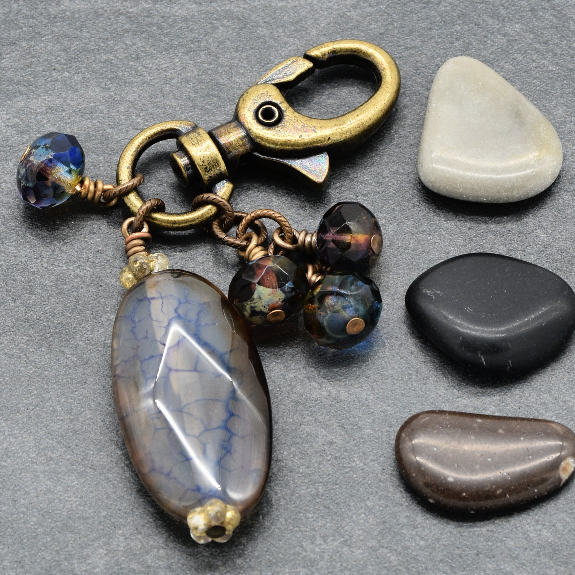 Jewelry keychain with beads and stones on a gray surface