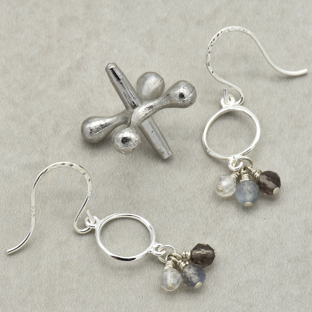 Silver earrings with gemstone drops on a gray background