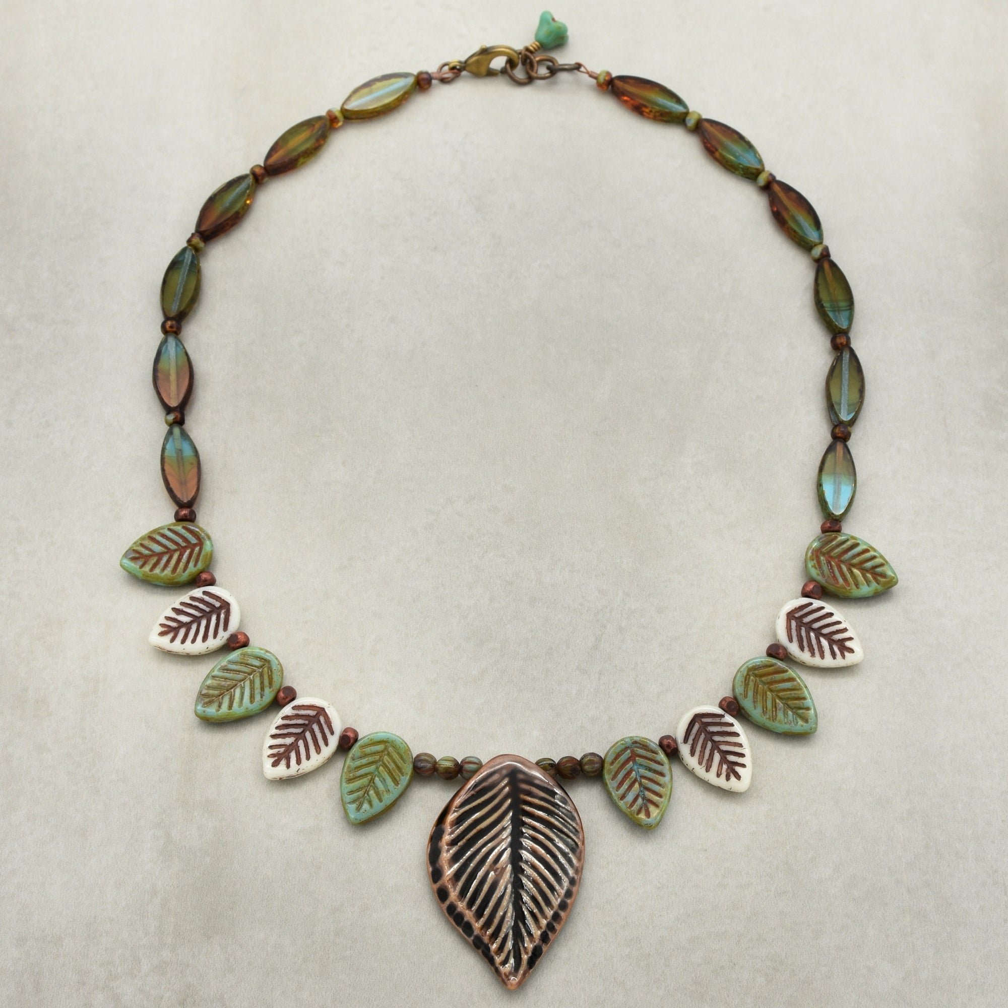Necklace with leaf-shaped beads on a light background