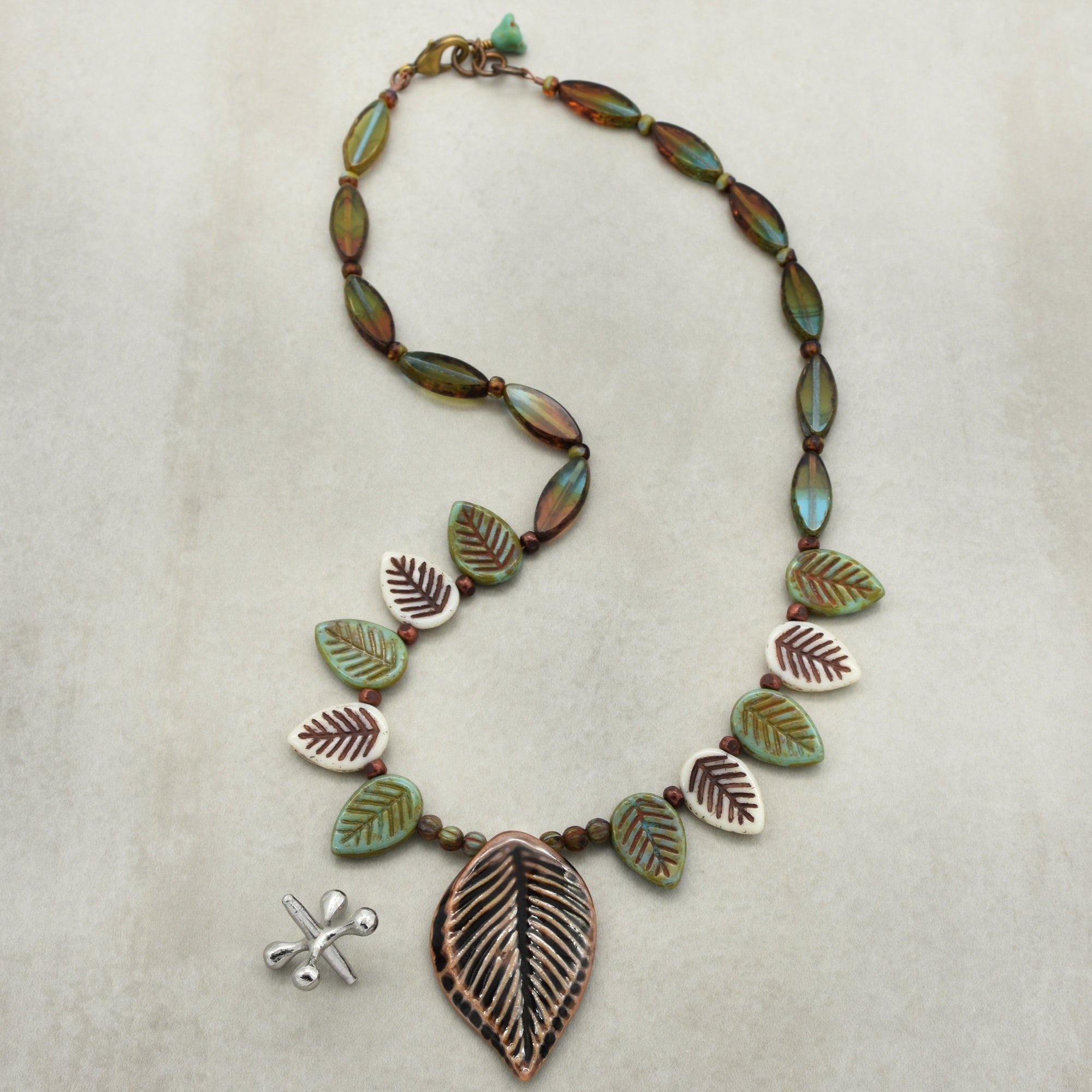 Necklace with leaf-shaped beads on a light background