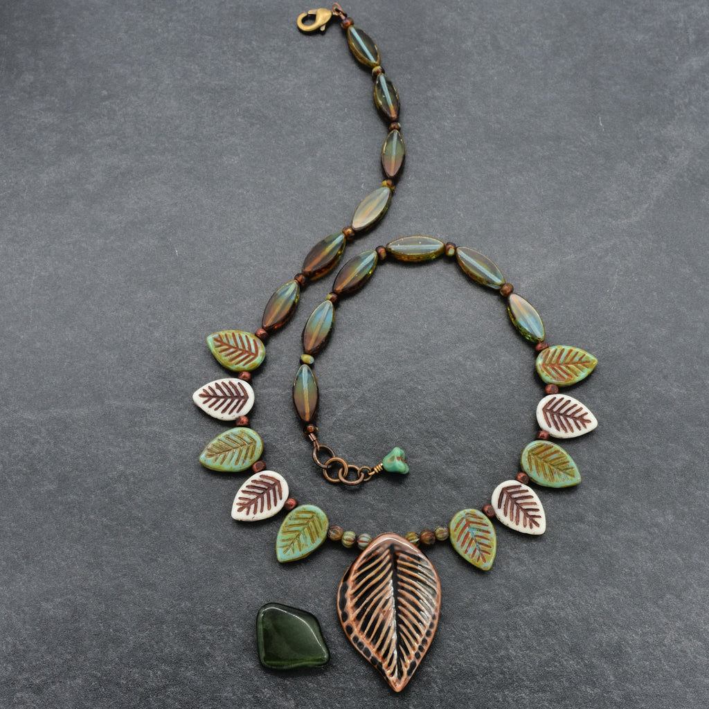 Necklace with leaf-shaped beads on a gray background
