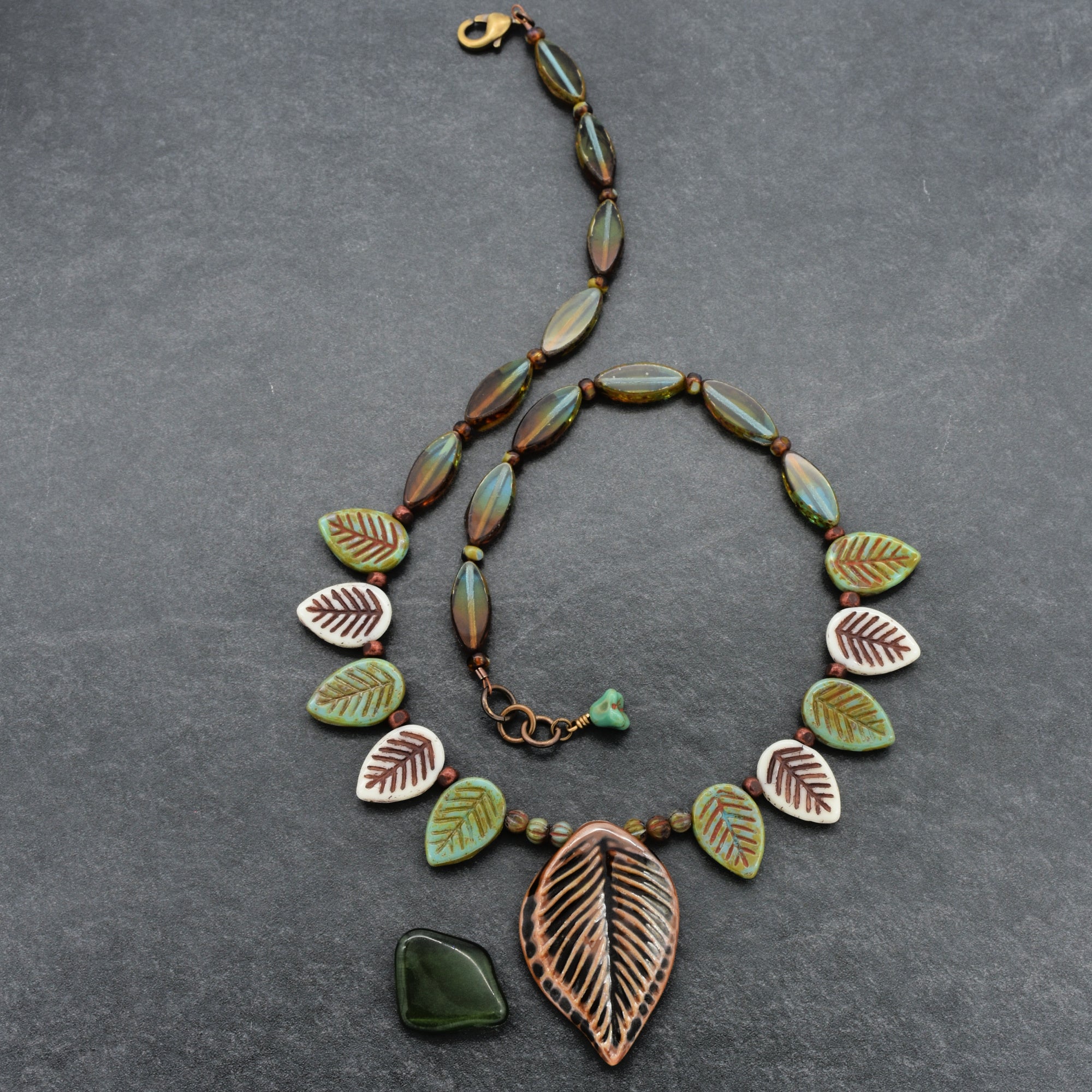 Necklace with leaf-shaped beads on a gray background