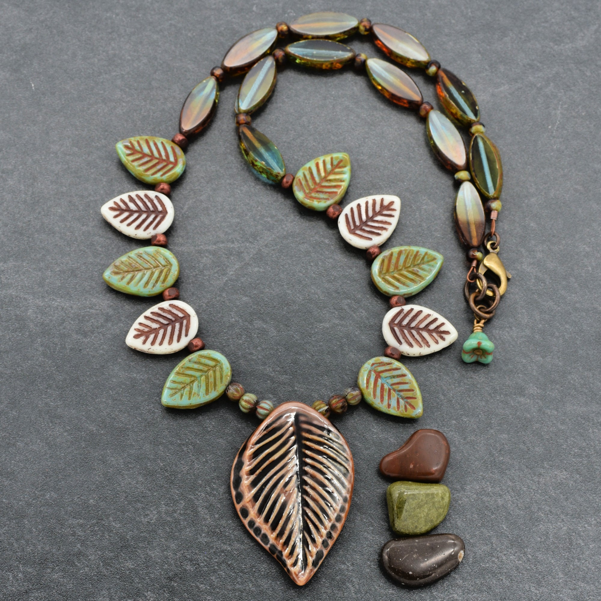 Necklace with leaf-shaped beads on a gray background