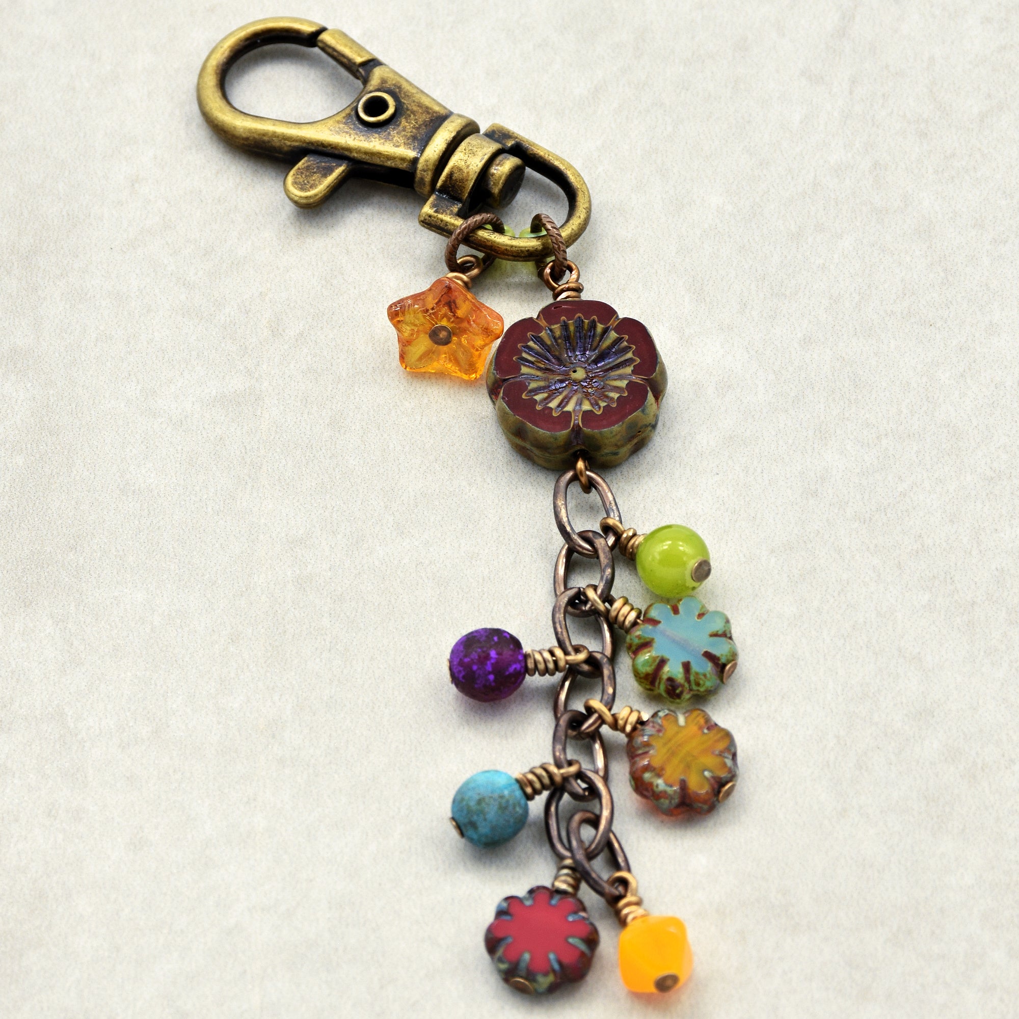 Colorful beaded keychain with floral designs on a white background