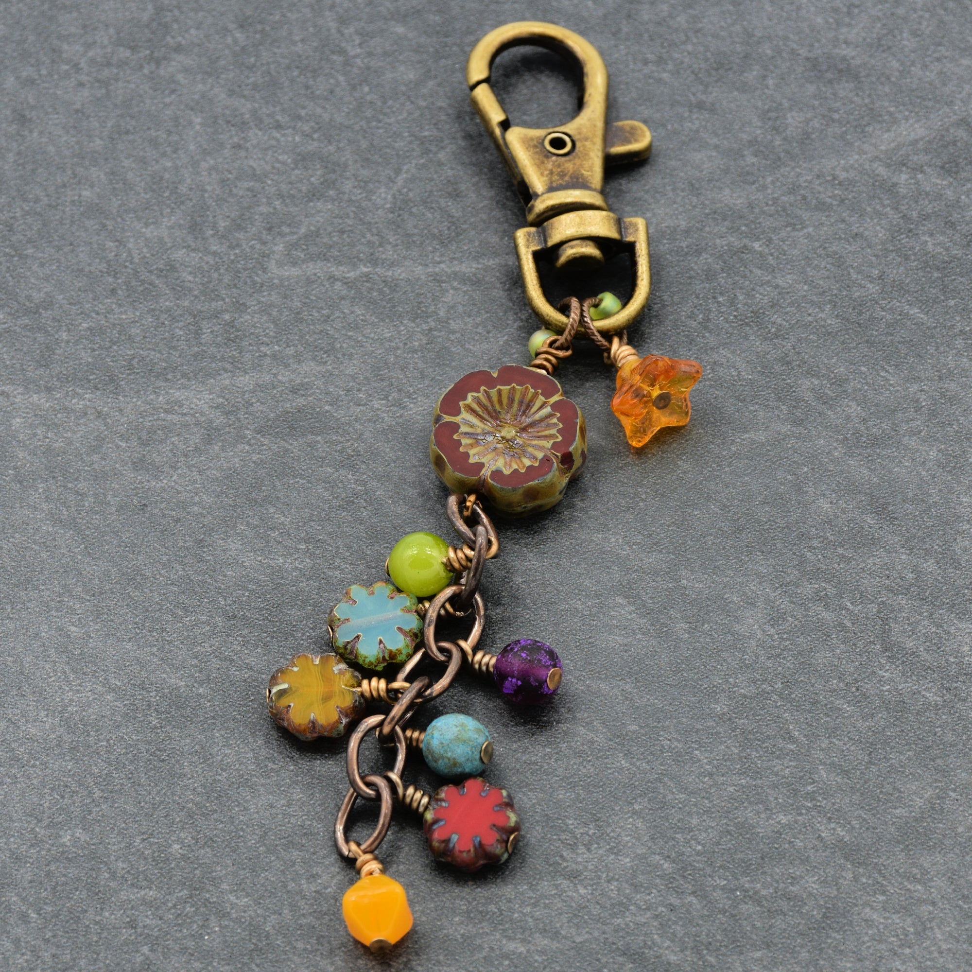 Colorful beaded keychain with a clasp on a gray background