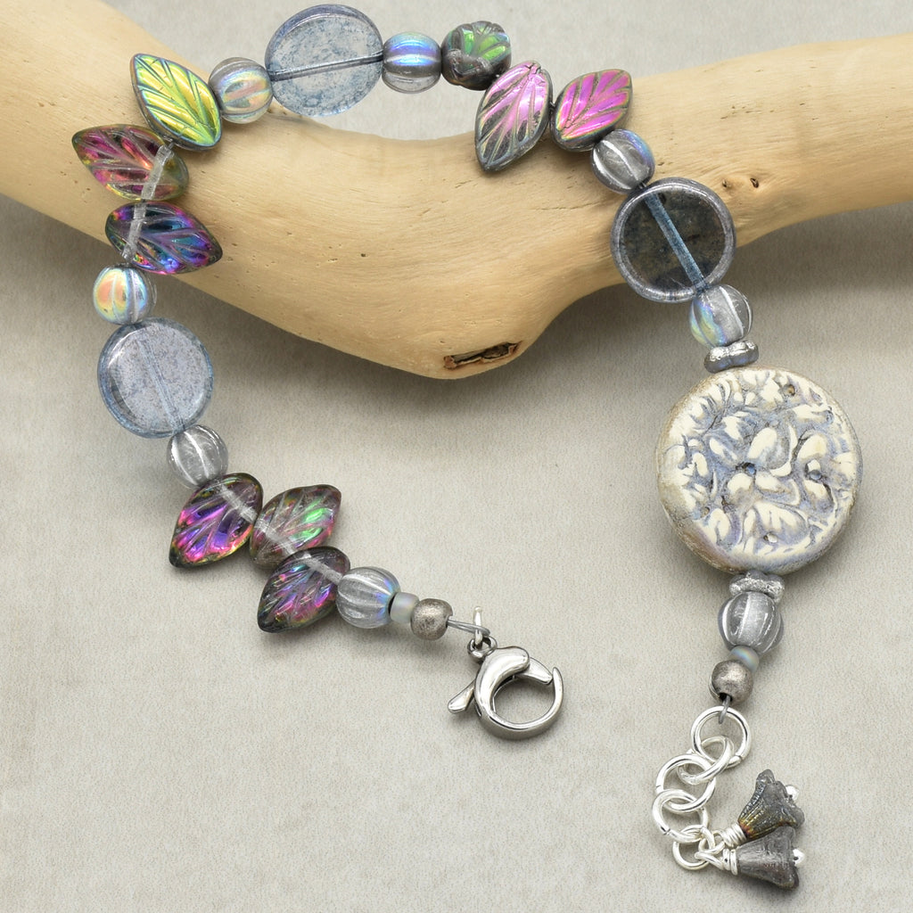 Bracelet with colorful beads and a clasp on a neutral background