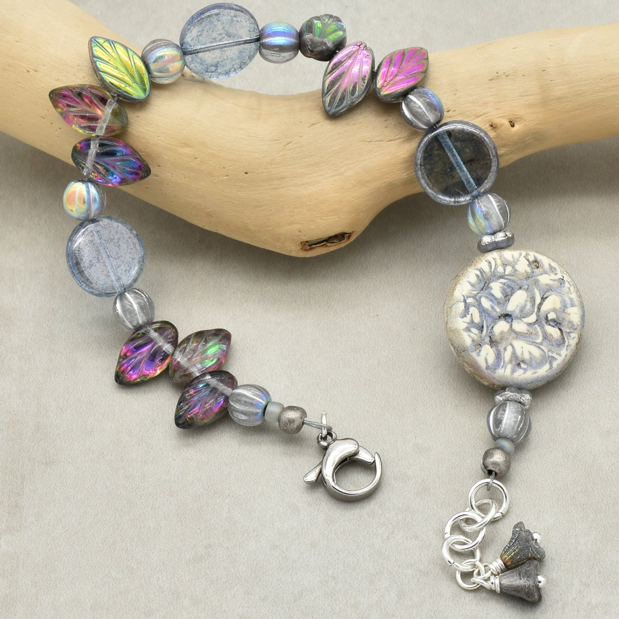 Bracelet with colorful beads and a clasp on a neutral background