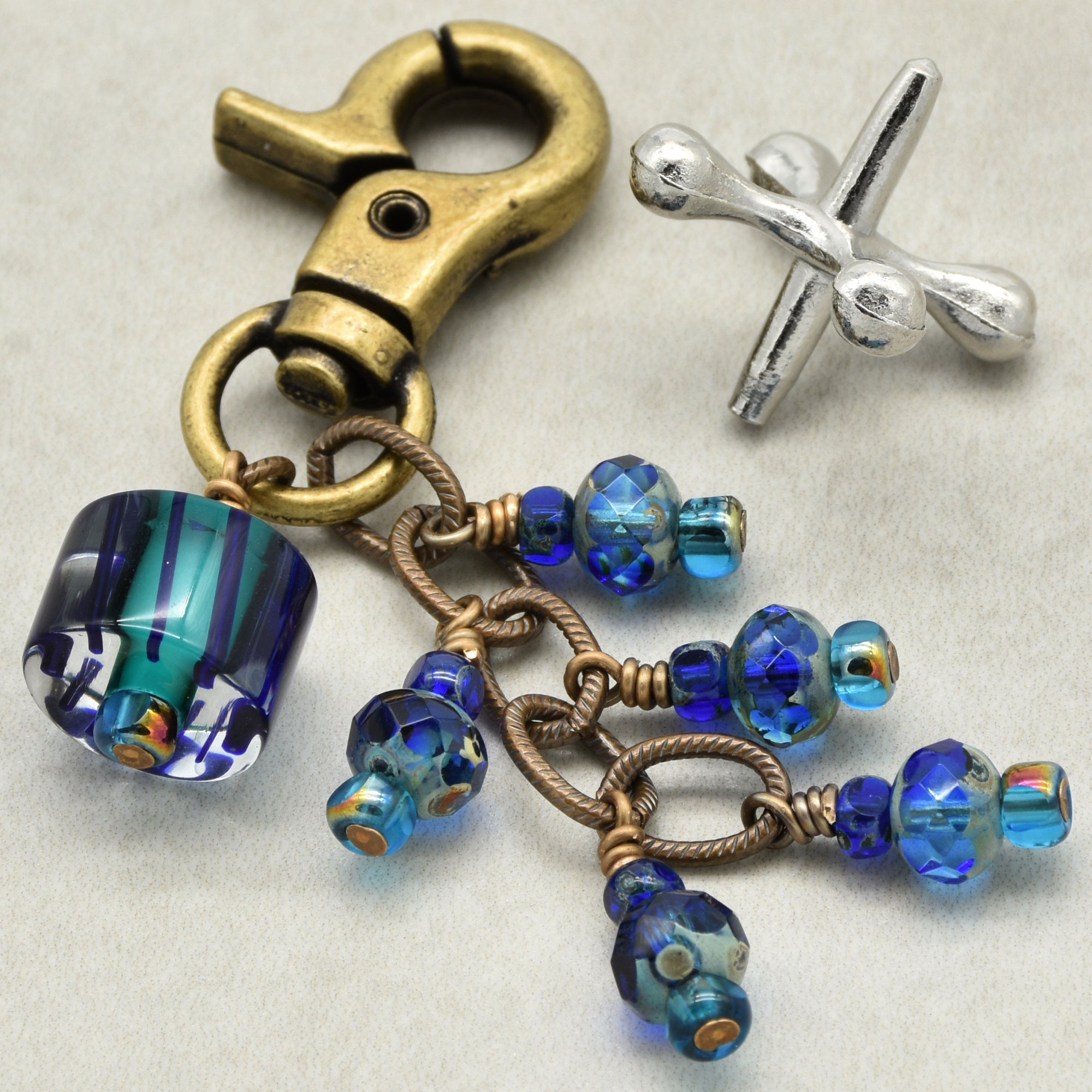 Keychain with blue beads and metal clasp on a light background