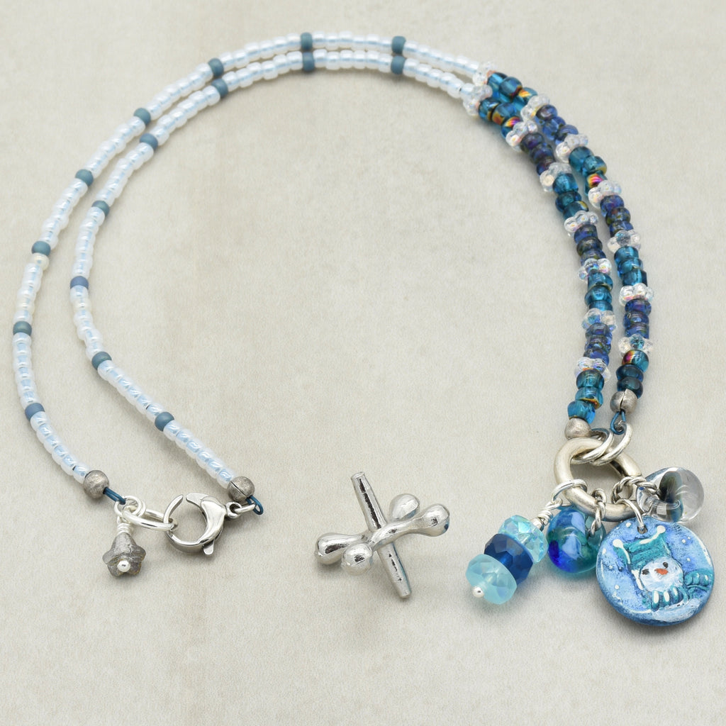 Festive beaded necklace with charms on a light gray background