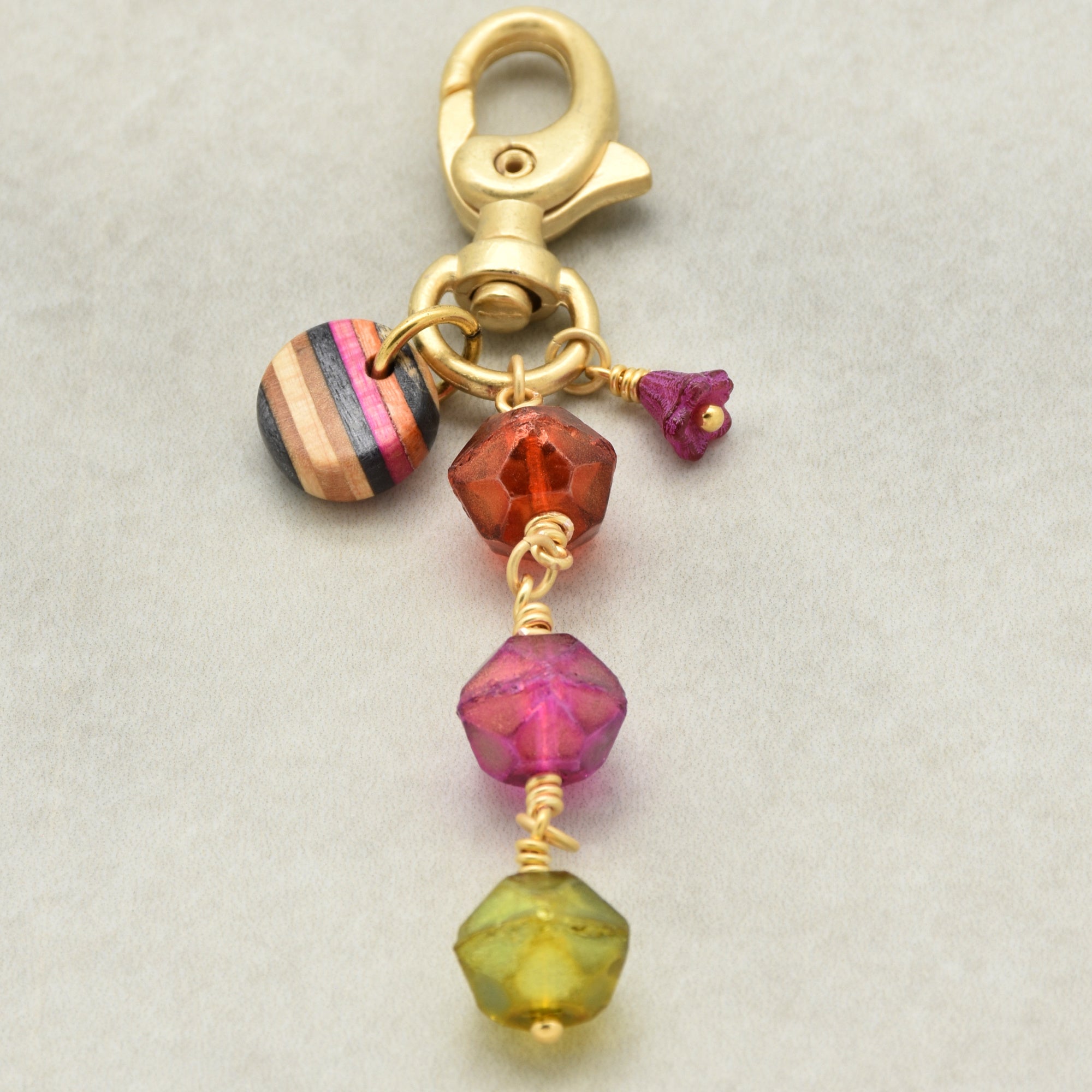 Gold keychain with colorful neon beads on a light gray background - handmade wearable art by Ruby Acorn