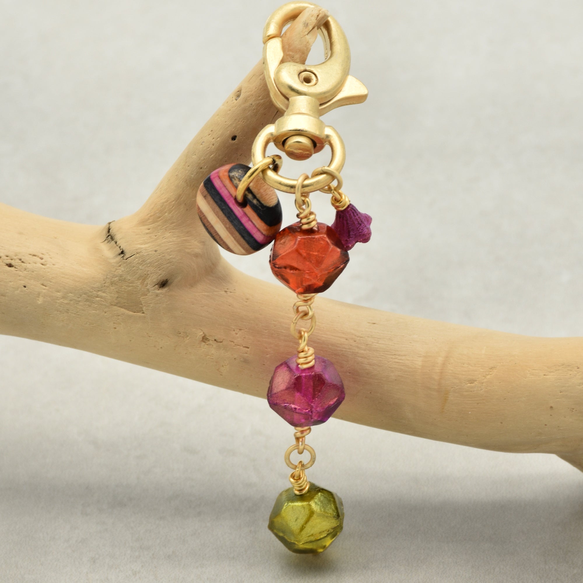 Gold keychain with neon colorful beads on a wooden branch - hand crafted by Ruby Acorn