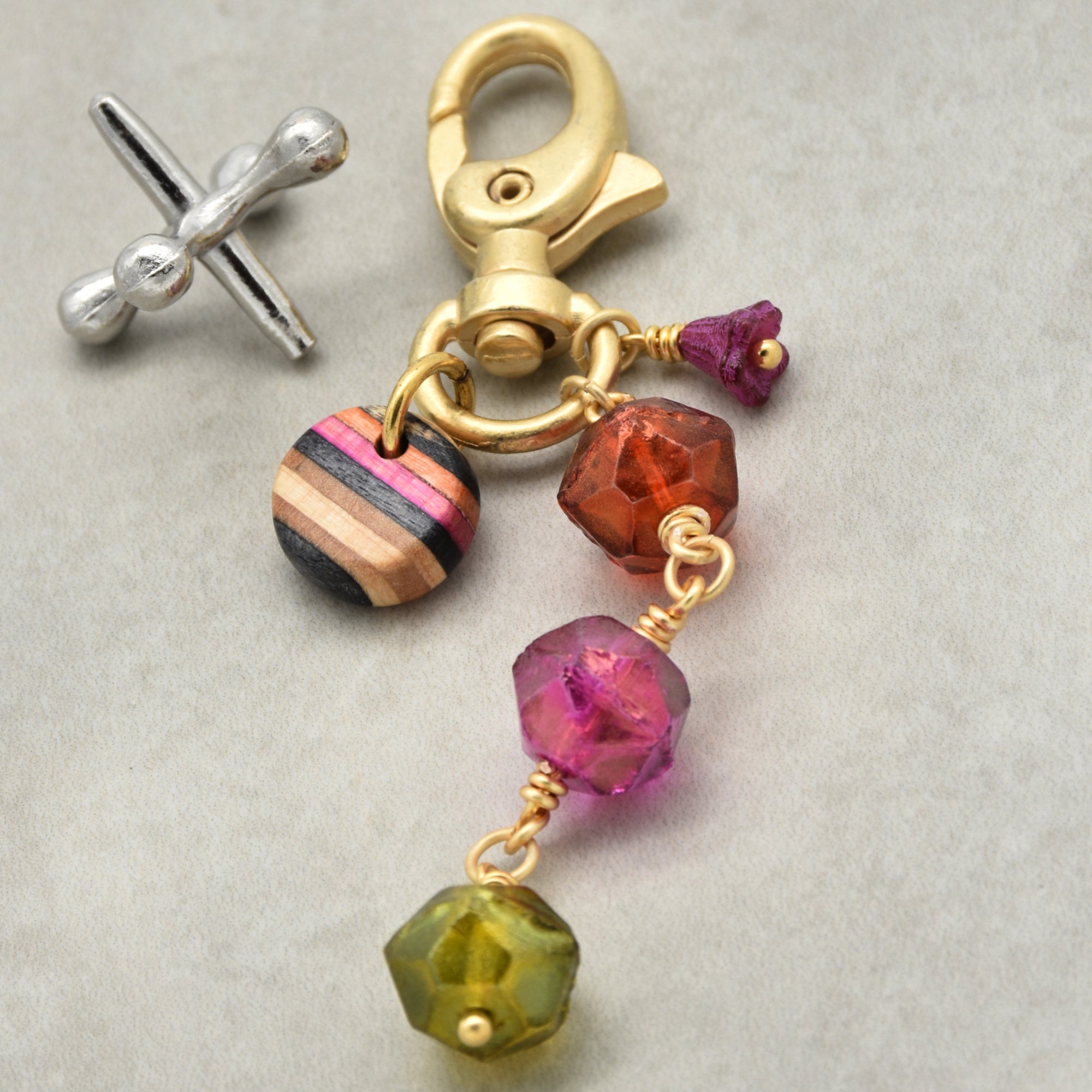 Colorful beaded keychain with gold clasp and neon colored glass beads on a neutral background - Ruby Acorn wearable art