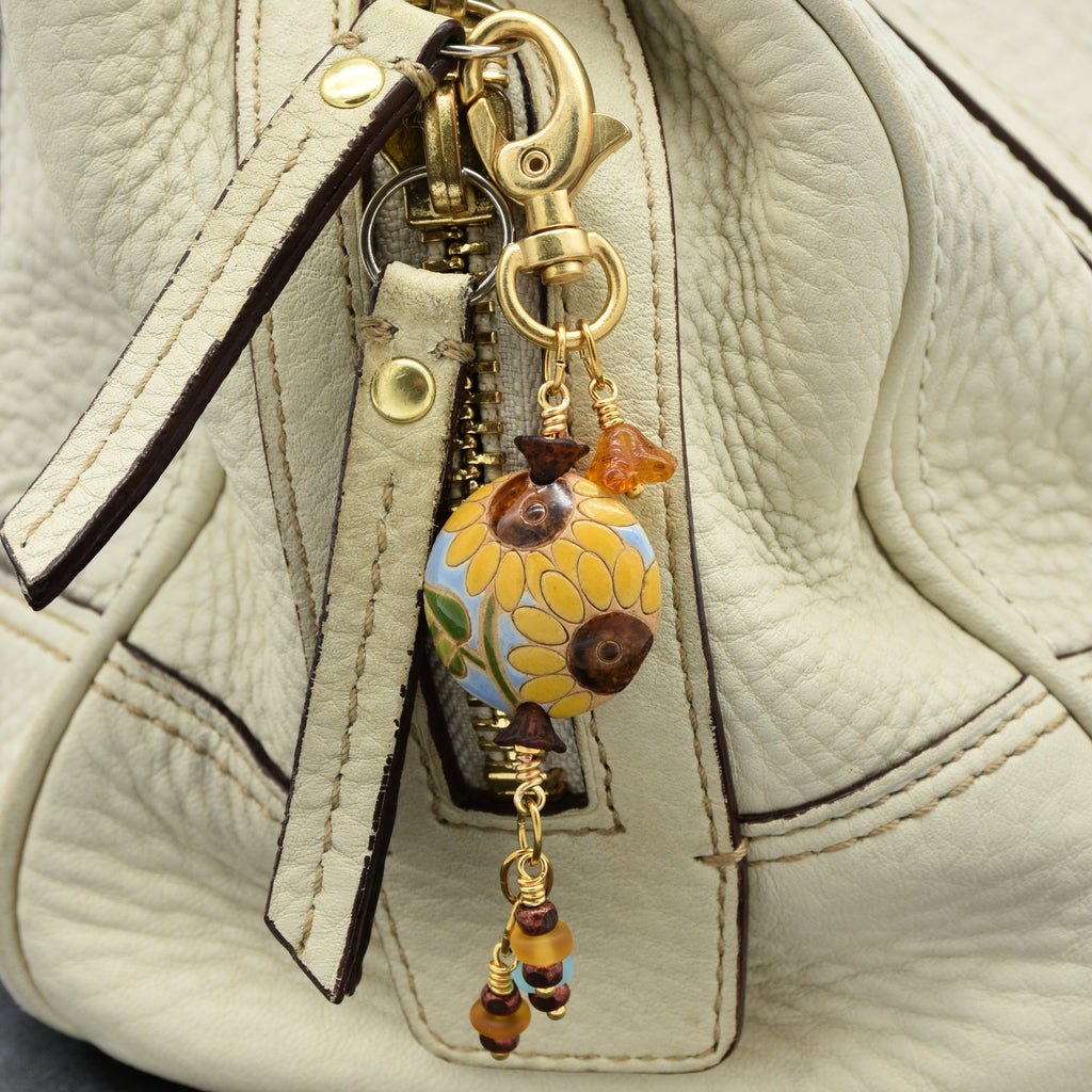 Colorful sunflower handbag charm with gold swivel lobster clasp on a cream purse - handmade with love by Ruby Acorn