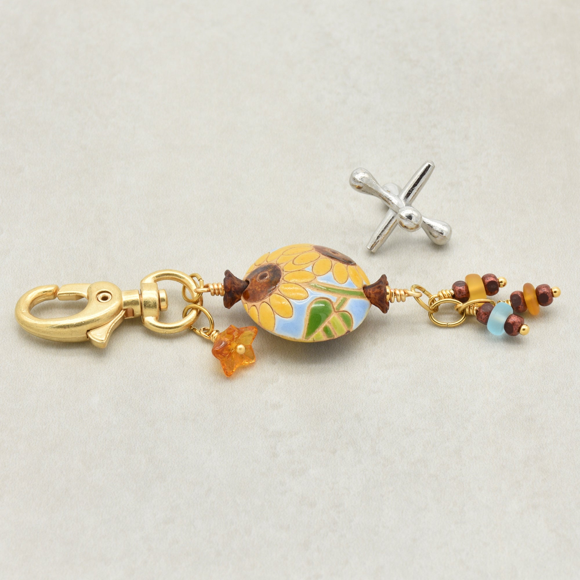 Colorful sunflower handbag charm with gold swivel lobster clasp on a light background - handmade with love by Ruby Acorn