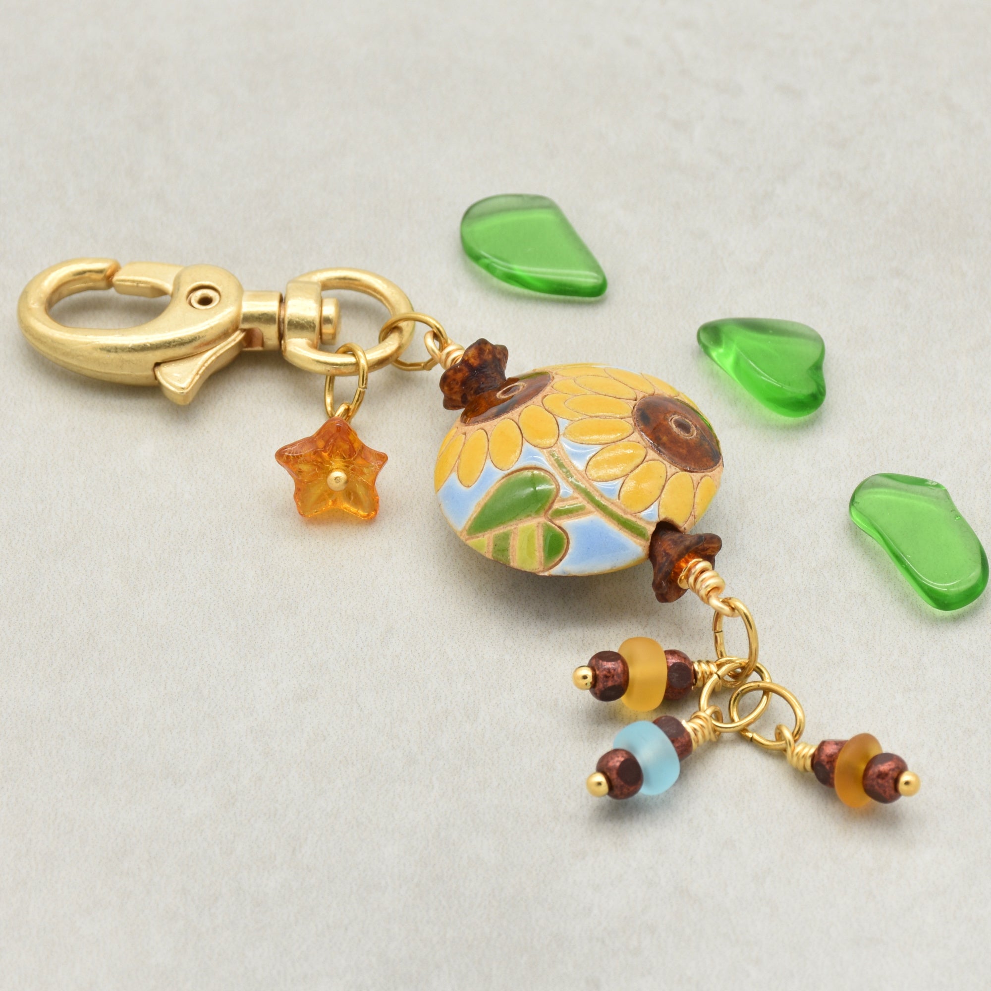 Colorful sunflower handbag charm with gold swivel lobster clasp on a light background - handmade with love by Ruby Acorn