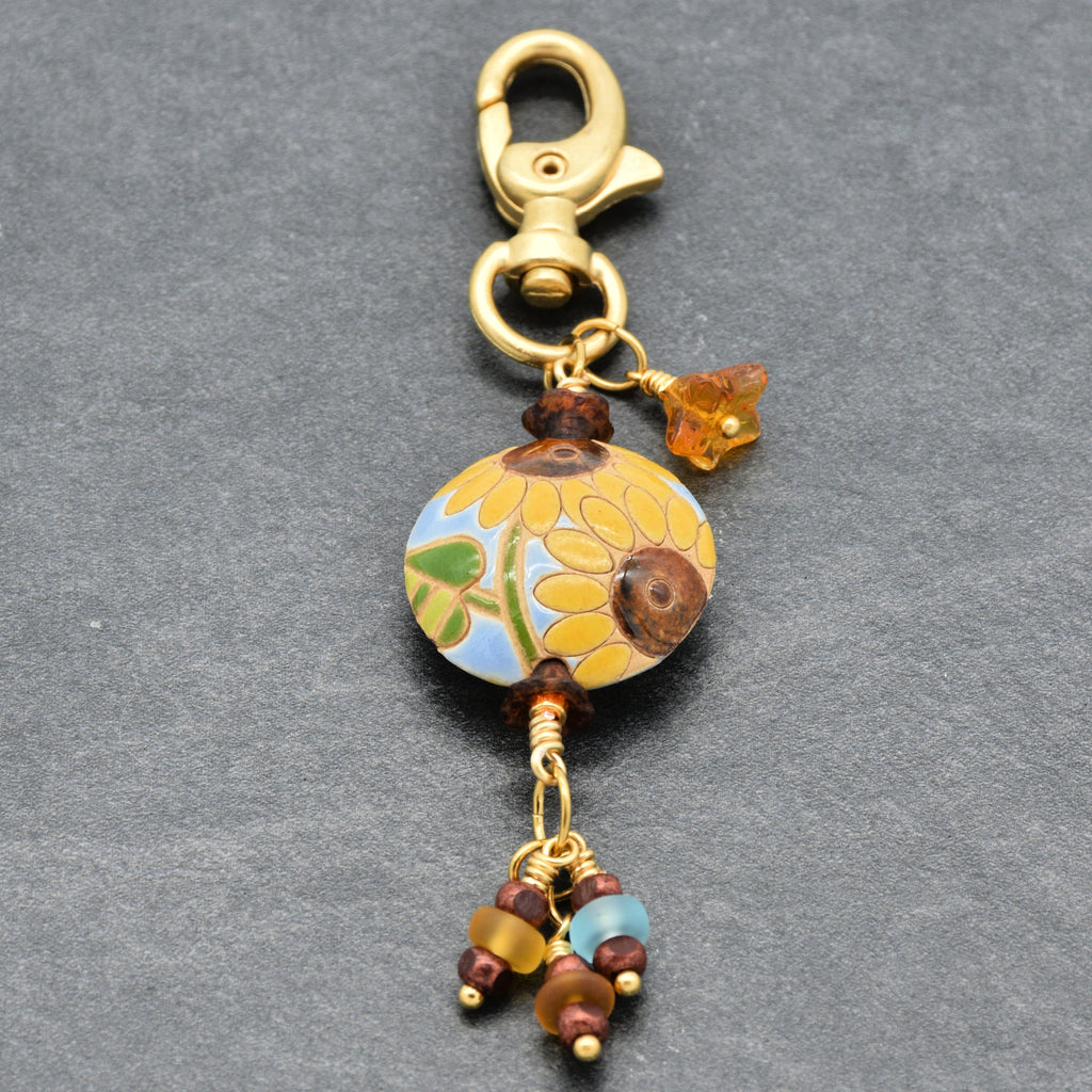 Colorful sunflower handbag charm with gold swivel lobster clasp on a gray background - handmade with love by Ruby Acorn