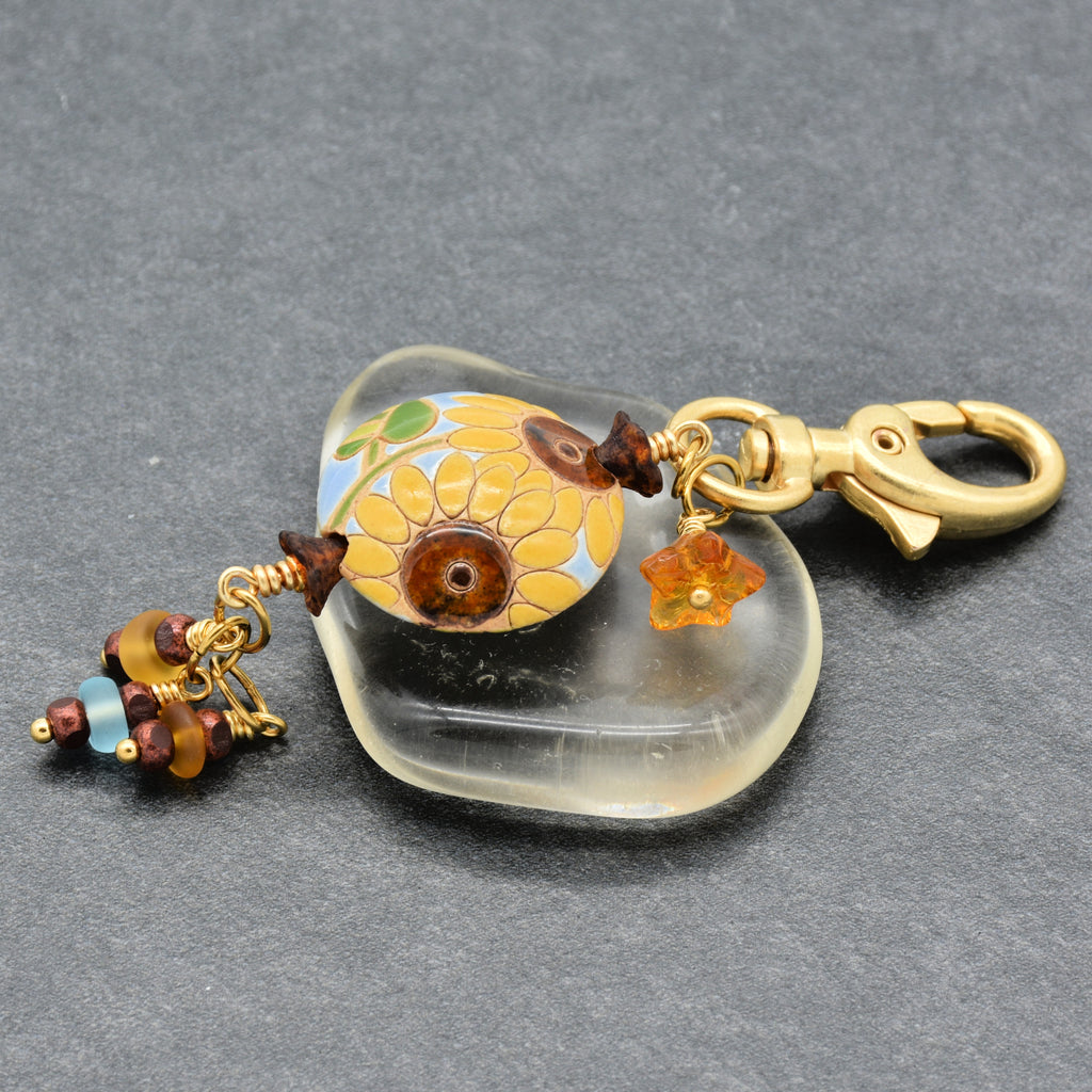 Colorful sunflower handbag charm with gold swivel lobster clasp on a gray background - handmade with love by Ruby Acorn