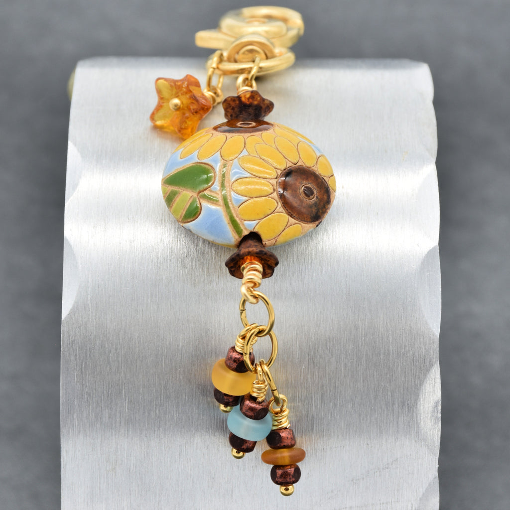 Colorful sunflower handbag charm with gold swivel lobster clasp on a silver background - handmade with love by Ruby Acorn
