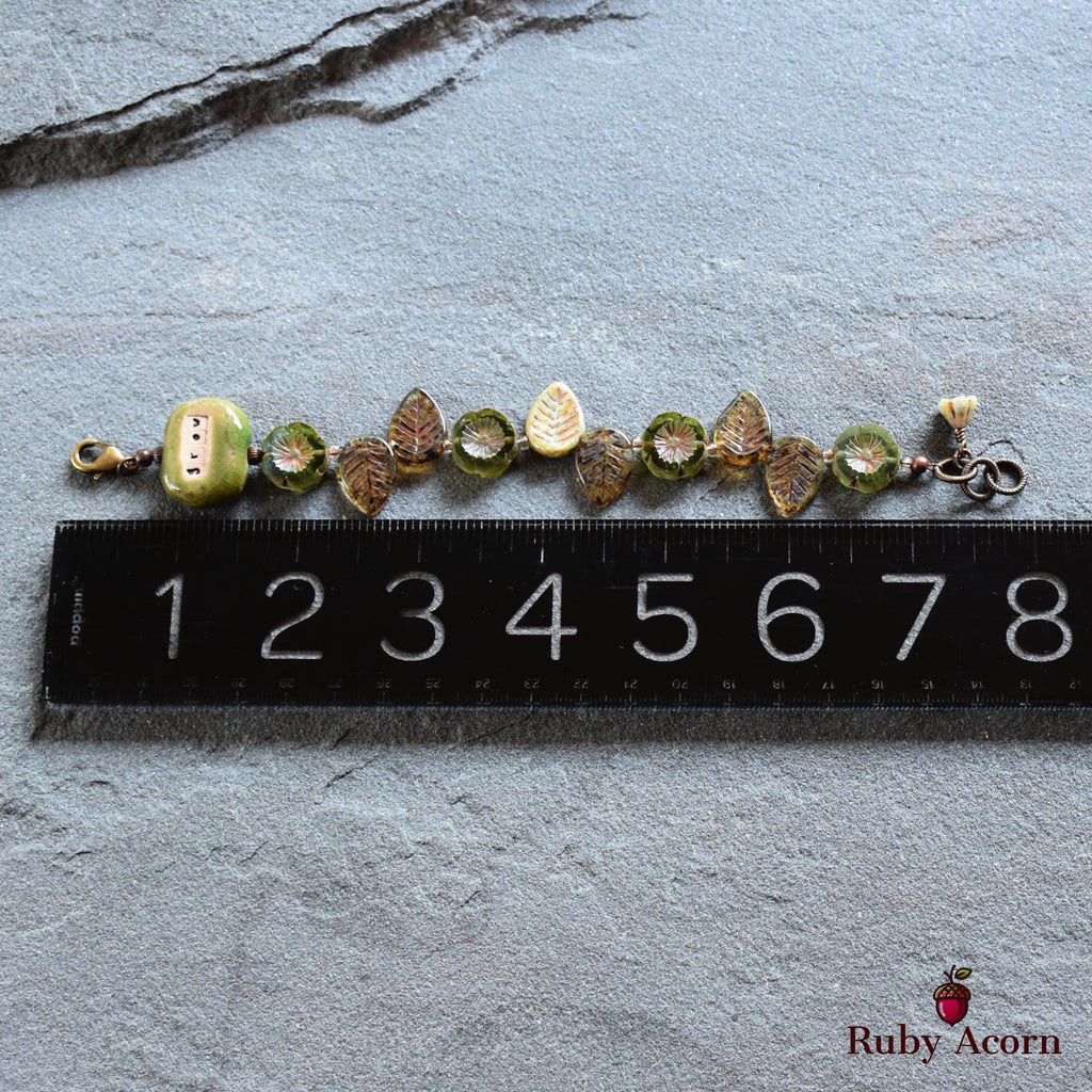 The item in the image appears to be a bracelet. It is relatively short, measuring about 7 centimeters, which is consistent with the size of a bracelet rather than a necklace or an earring. The clasp on one end also indicates it is designed to be worn around the wrist.