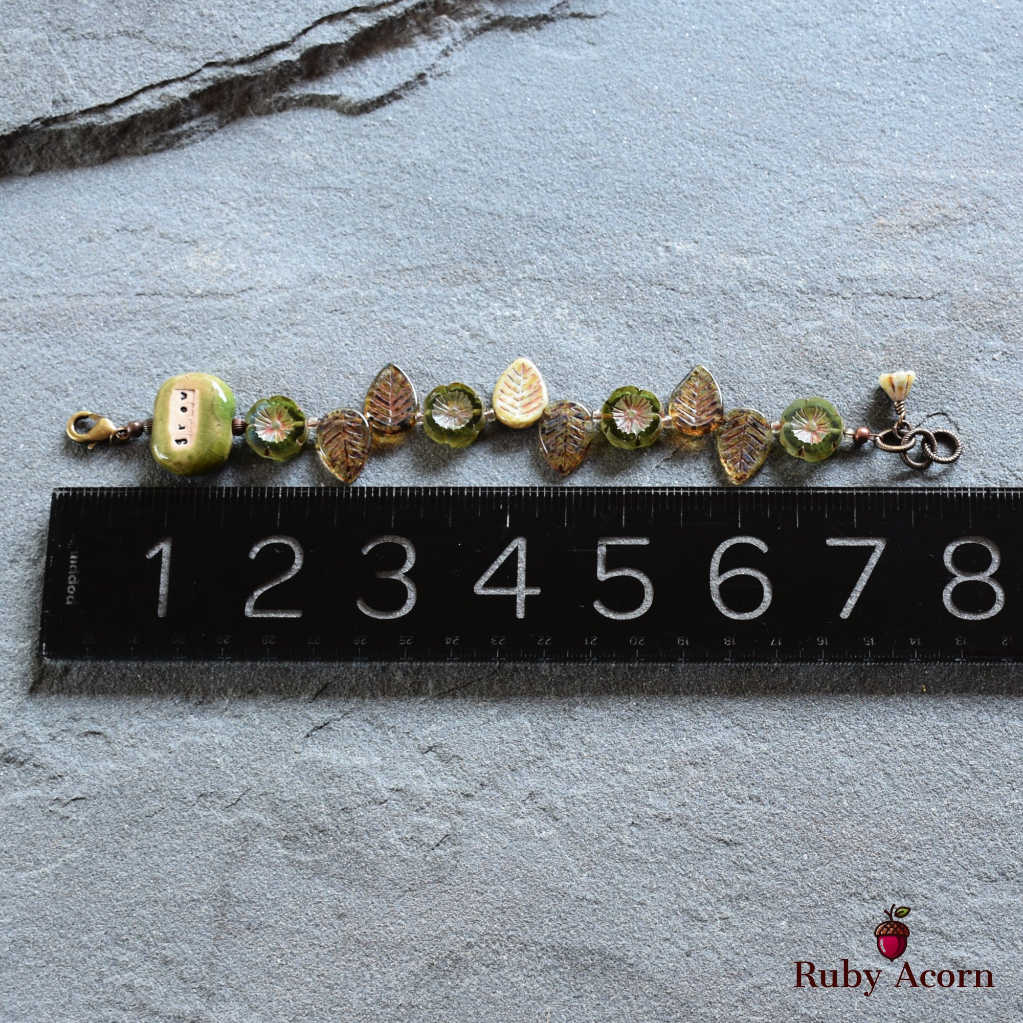 The item in the image appears to be a bracelet. It is relatively short, measuring about 7 centimeters, which is consistent with the size of a bracelet rather than a necklace or an earring. The clasp on one end also indicates it is designed to be worn around the wrist.