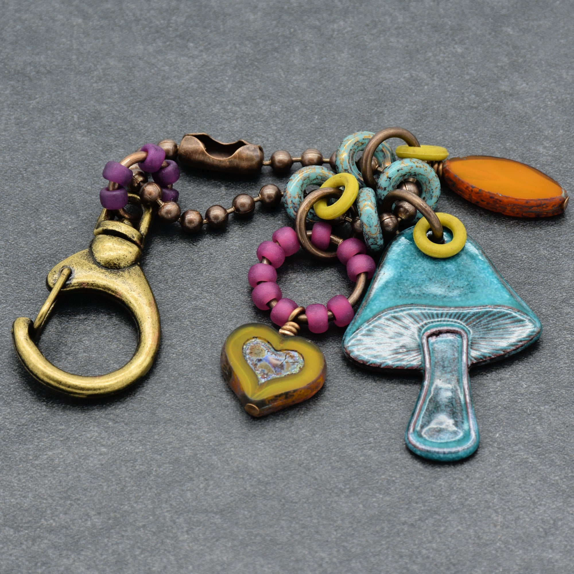 Colorful keychain with various charms on a gray background