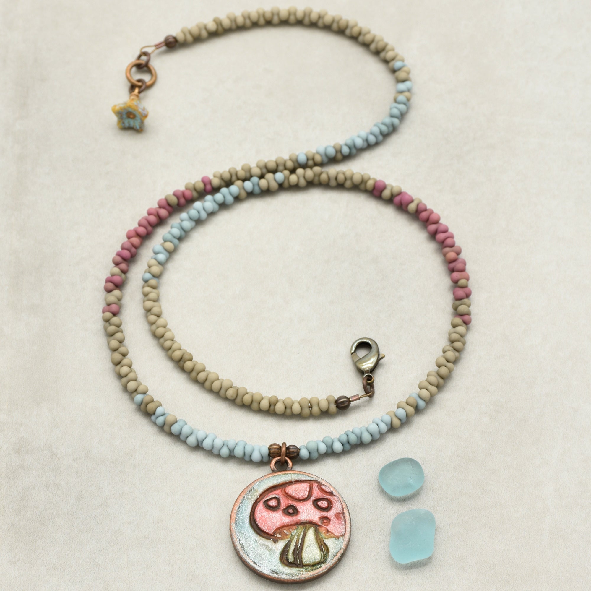 Necklace with a mushroom pendant on a beige background