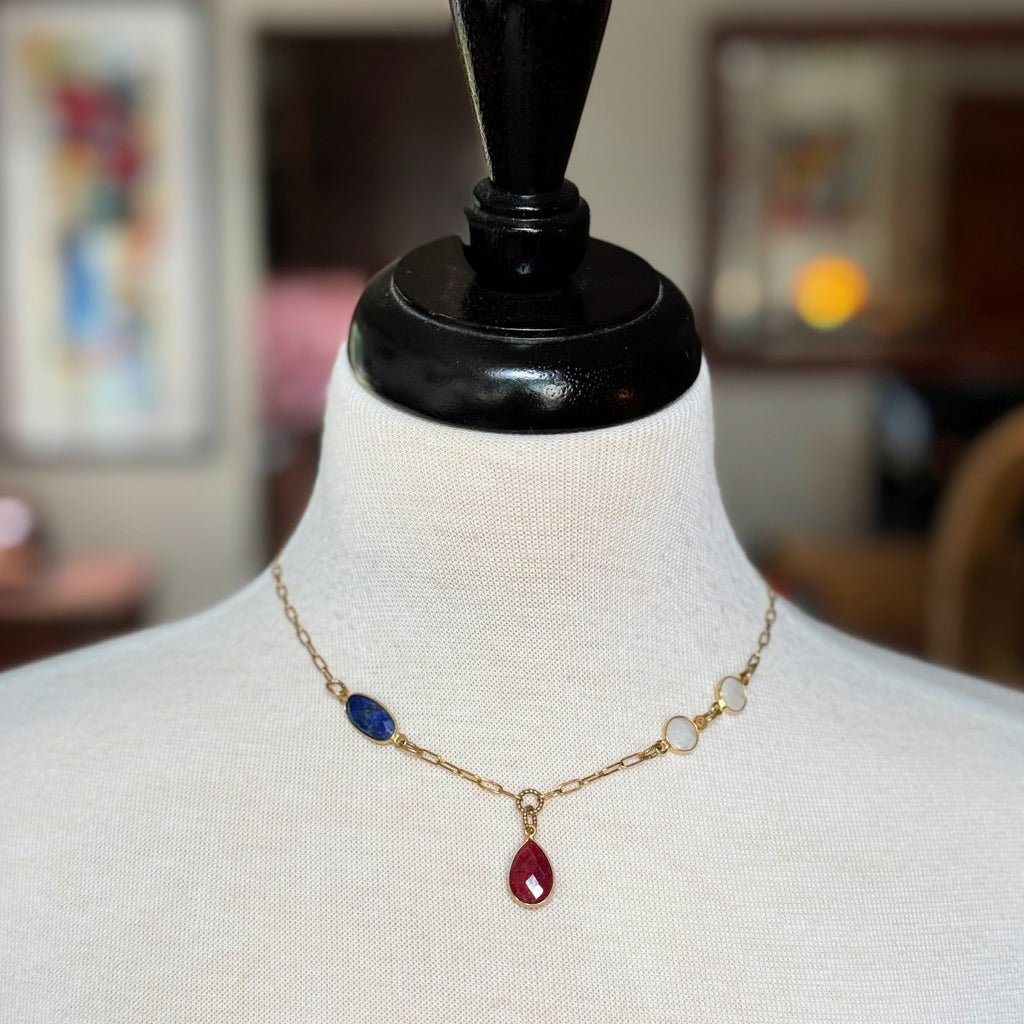 Delicate gold chain choker necklace with ruby pendant, lapis and rainbow moonstone links on a mannequin - art you can wear by Ruby Acorn