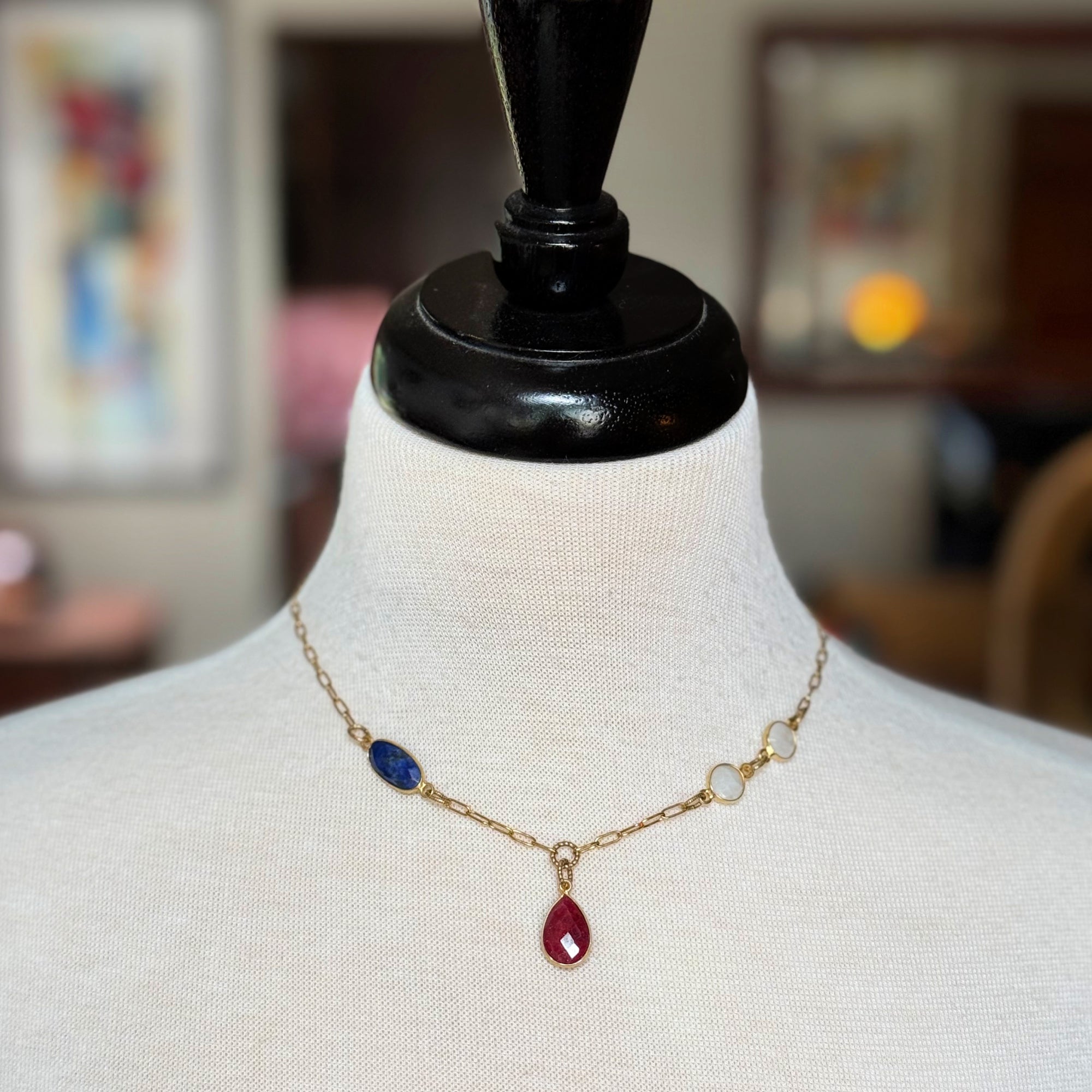 Delicate gold chain choker necklace with ruby pendant, lapis and rainbow moonstone links on a mannequin - art you can wear by Ruby Acorn