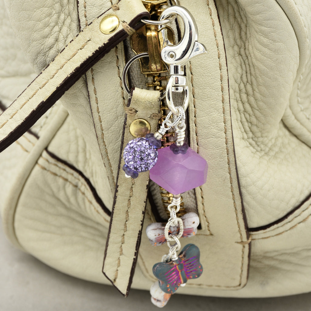 Lilac quartz handbag charm with butterfly charms on a cream purse - handmade with love by Ruby Acorn