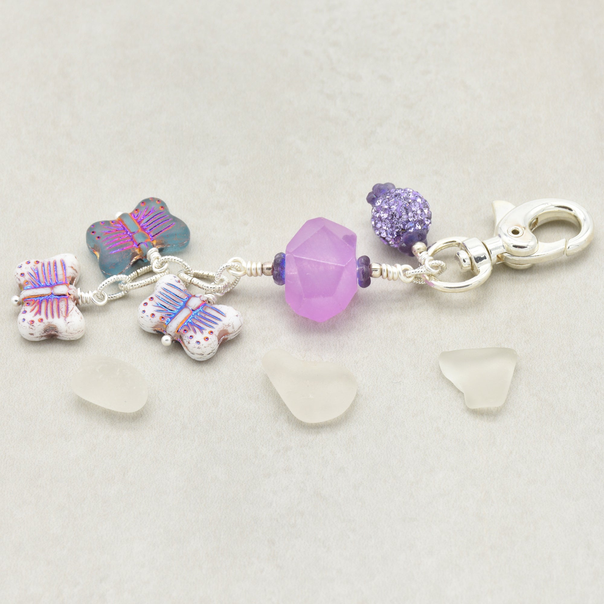 Lilac quartz handbag charm with butterfly charms on a light background - handmade with love by Ruby Acorn