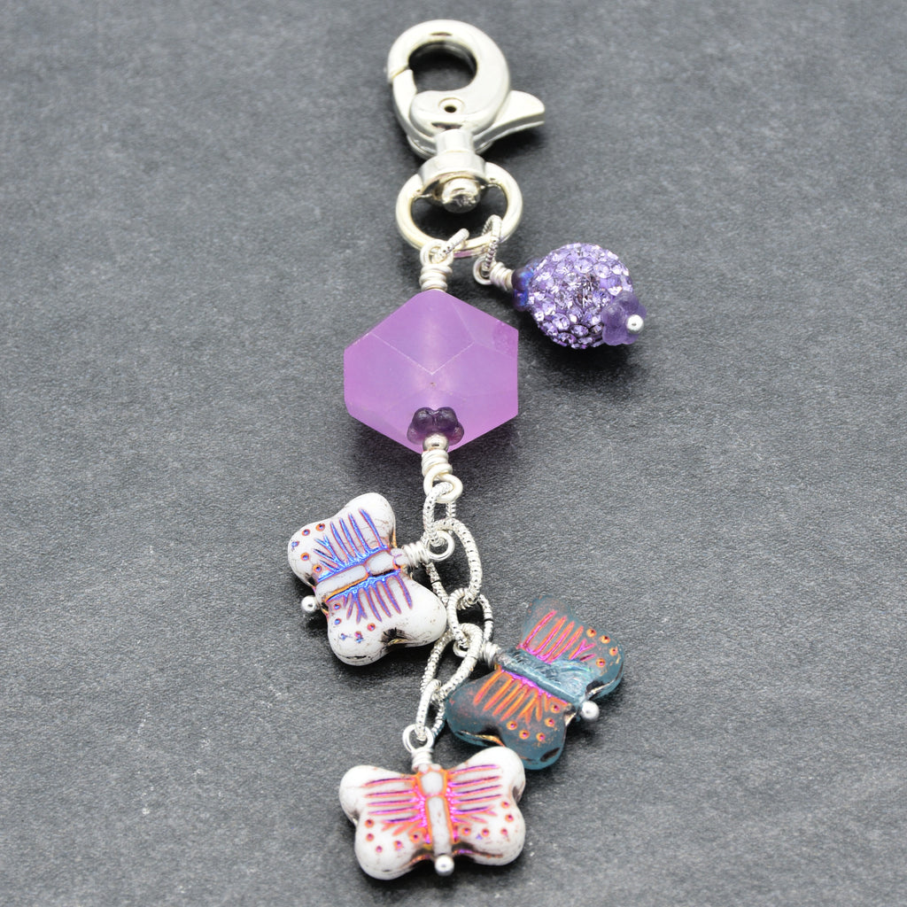 Lilac quartz handbag charm with butterfly charms on a gray background - handmade with love by Ruby Acorn