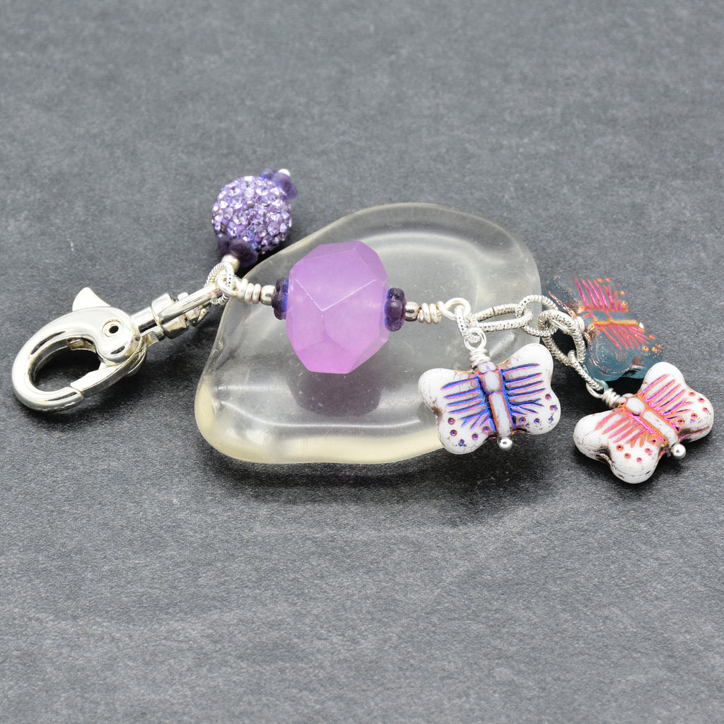 Lilac quartz handbag charm with butterfly charms on a gray background - handmade with love by Ruby Acorn