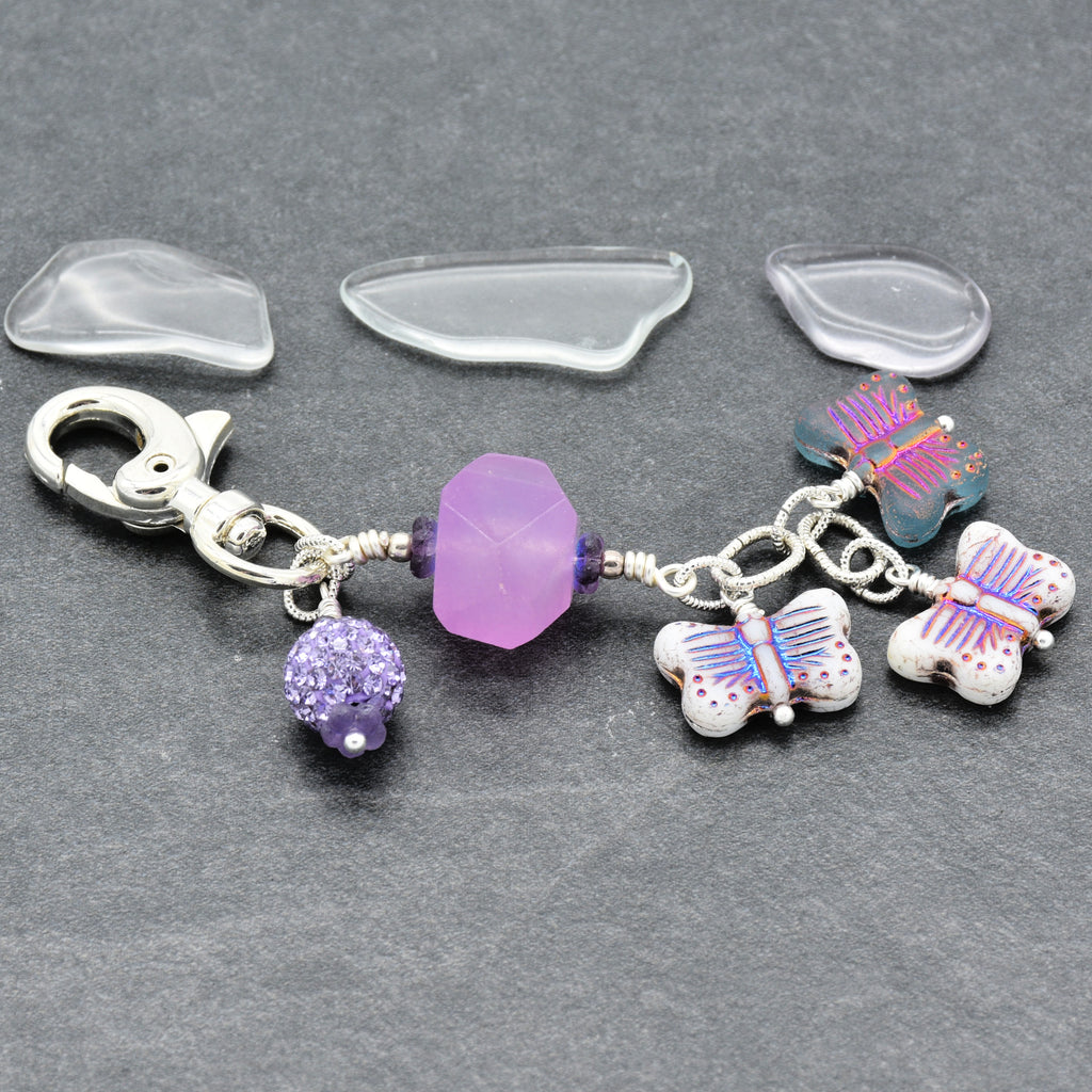 Lilac quartz handbag charm with butterfly charms on a gray background - handmade with love by Ruby Acorn