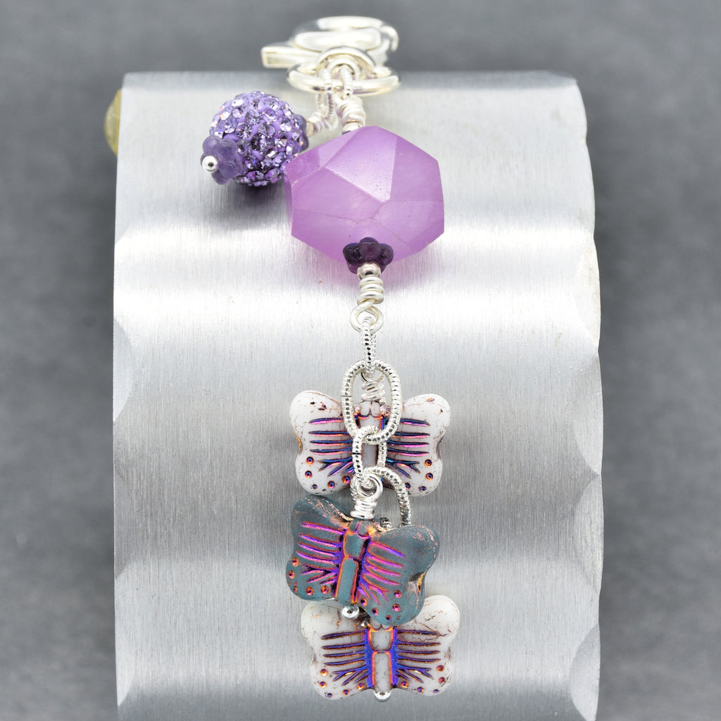 Lilac quartz handbag charm with butterfly charms on a gray background - handmade with love by Ruby Acorn