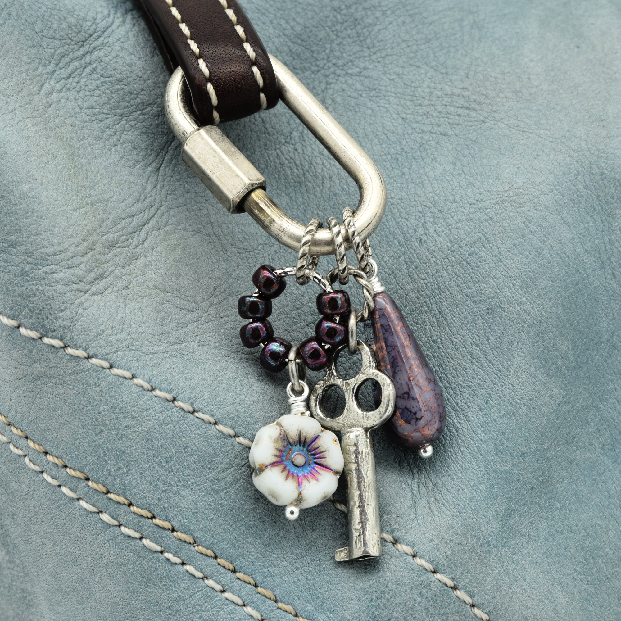 Keychain with charms on a leather surface