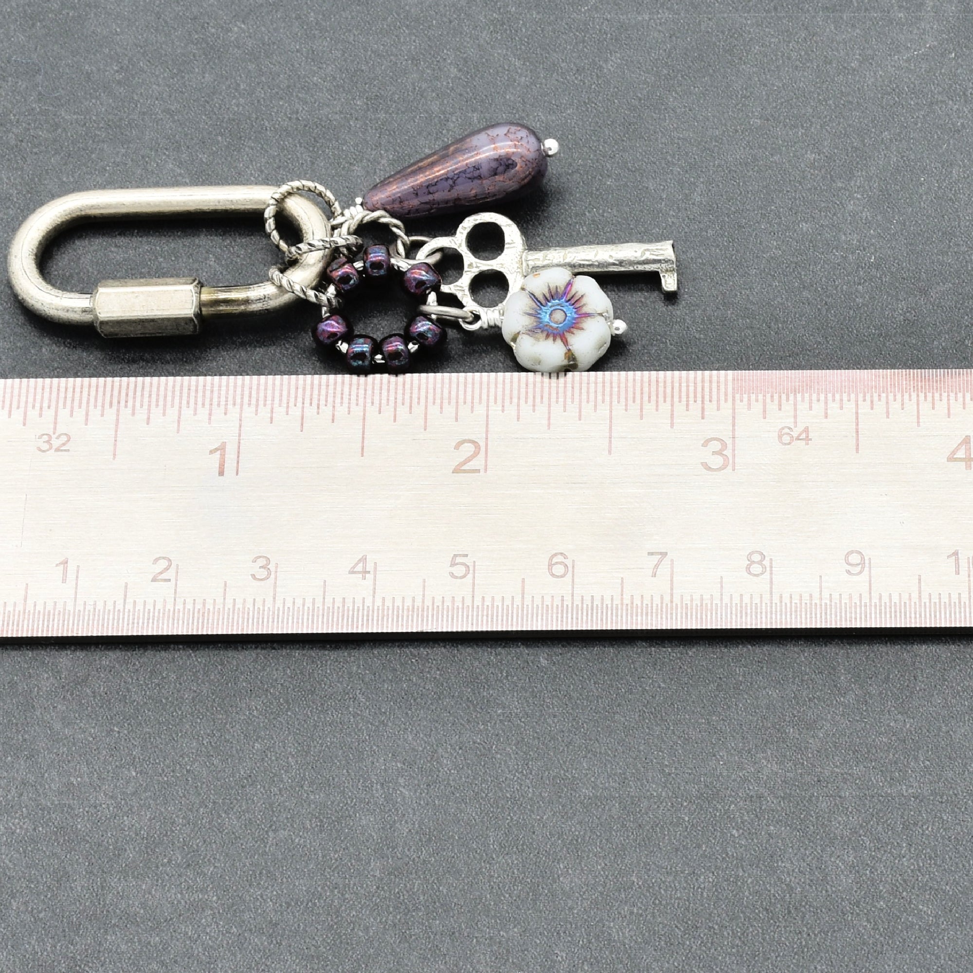 Keychain with charms on a ruler for size reference