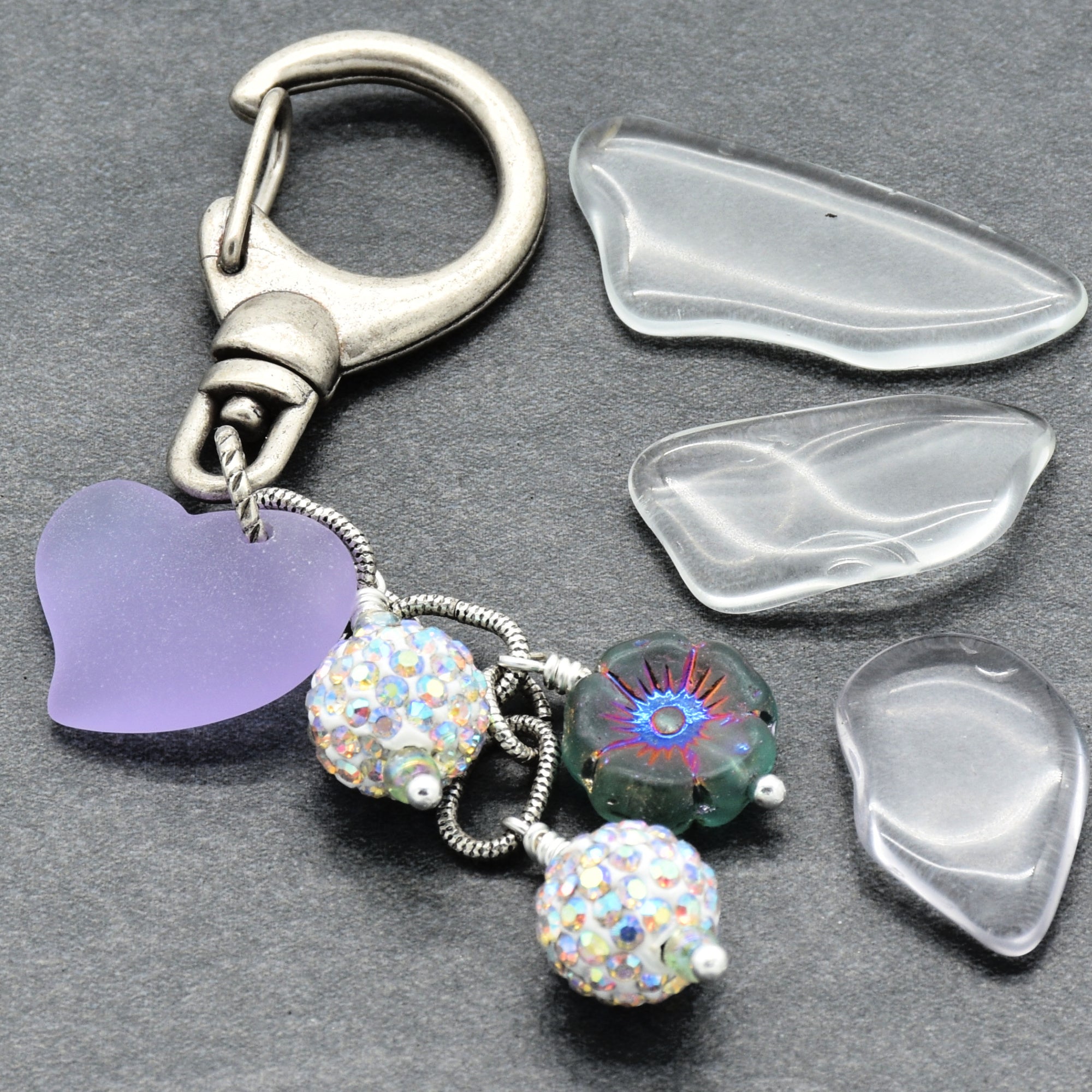 Keychain with heart-shaped charm and beads on a gray background