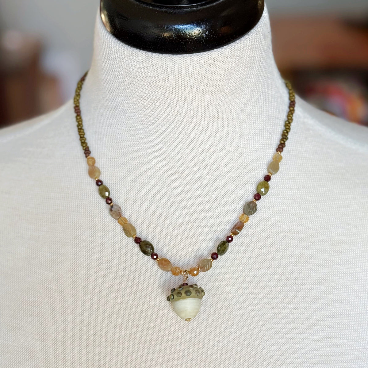 Forest Fable Necklace featuring artisan lampwork glass acorn focal with green garnet, red garnet and citrine, handmade by Ruby Acorn