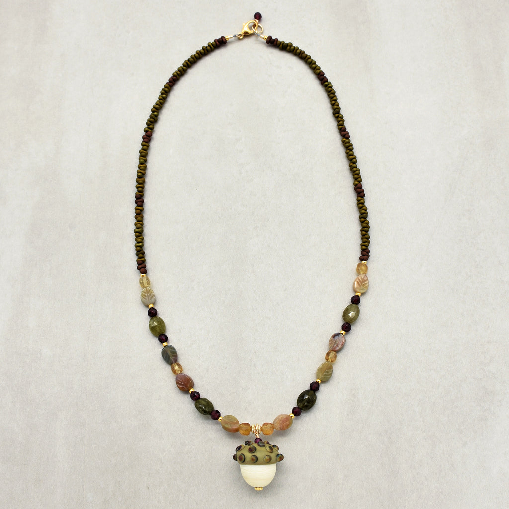Forest Fable Necklace featuring artisan lampwork glass acorn focal with green garnet, red garnet and citrine, handmade by Ruby Acorn