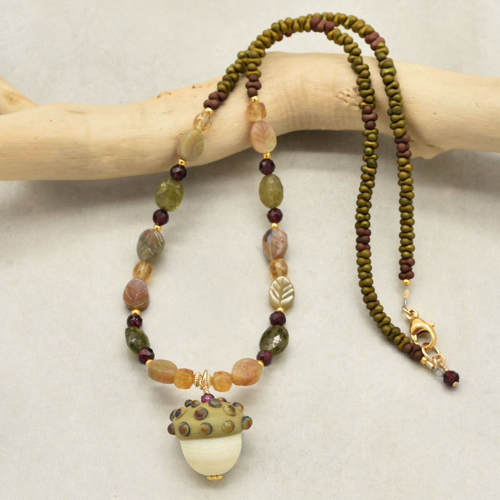 Forest Fable Necklace featuring artisan lampwork glass acorn focal with green garnet, red garnet and citrine, handmade by Ruby Acorn