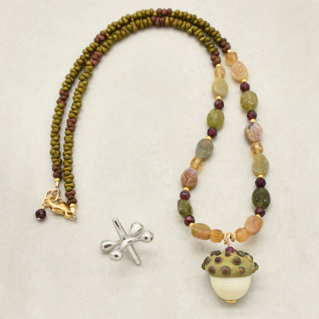 Forest Fable Necklace featuring artisan lampwork glass acorn focal with green garnet, red garnet and citrine, handmade by Ruby Acorn